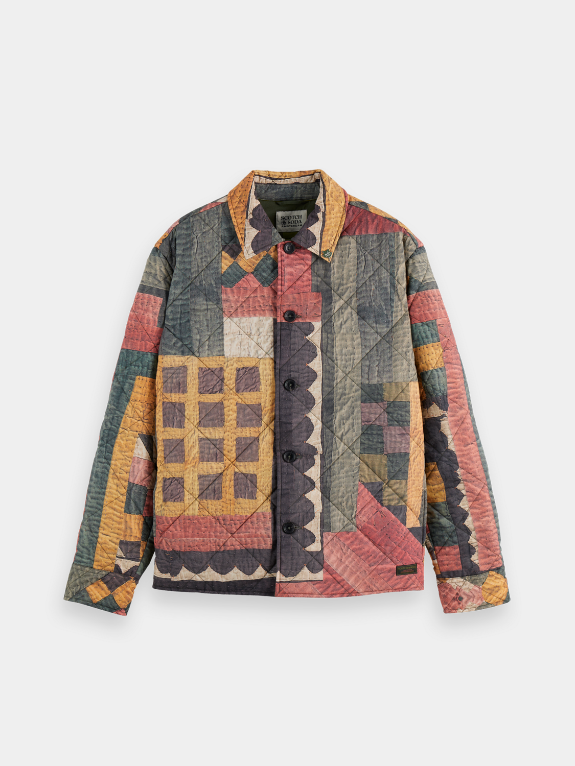 Patchwork overshirt jacket by Scotch & Soda with mixed fabric panels and button front, displayed on a hanger.