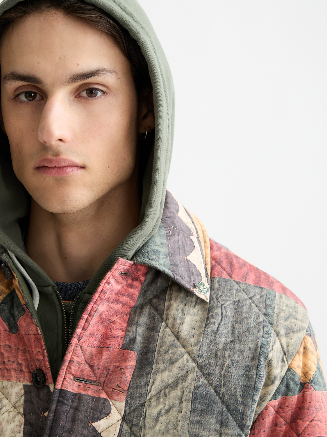 Scotch & Soda patchwork overshirt jacket with mixed fabric panels, button front, and casual style on a plain background.