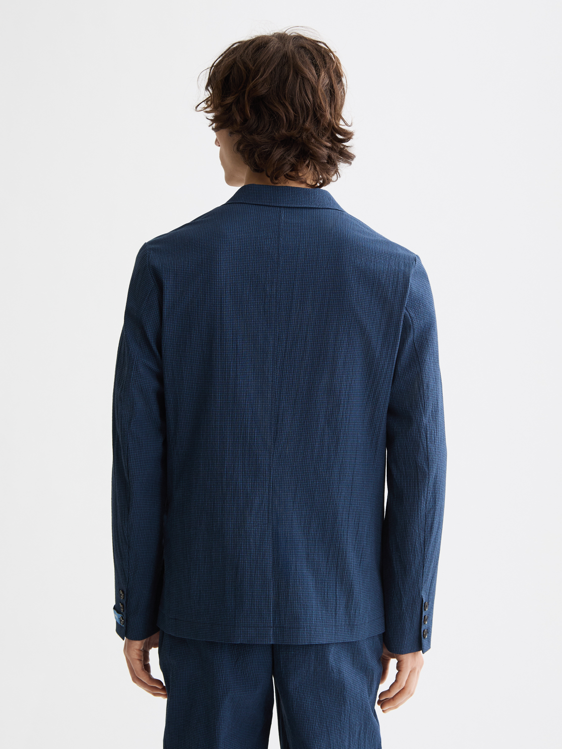 SCOTCH & SODA seersucker blazer showing the back view, with a textured, lightweight fabric in a classic blazer style.