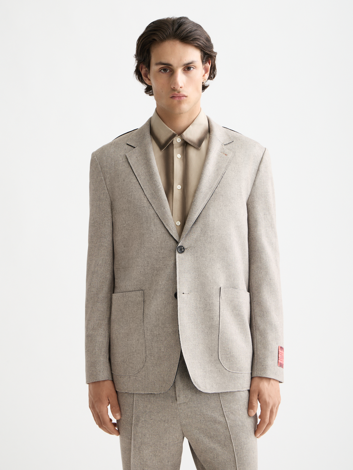 Unconstructed Scotch & Soda blazer in dark fabric, showcasing a tailored fit with notch lapel and front pockets.