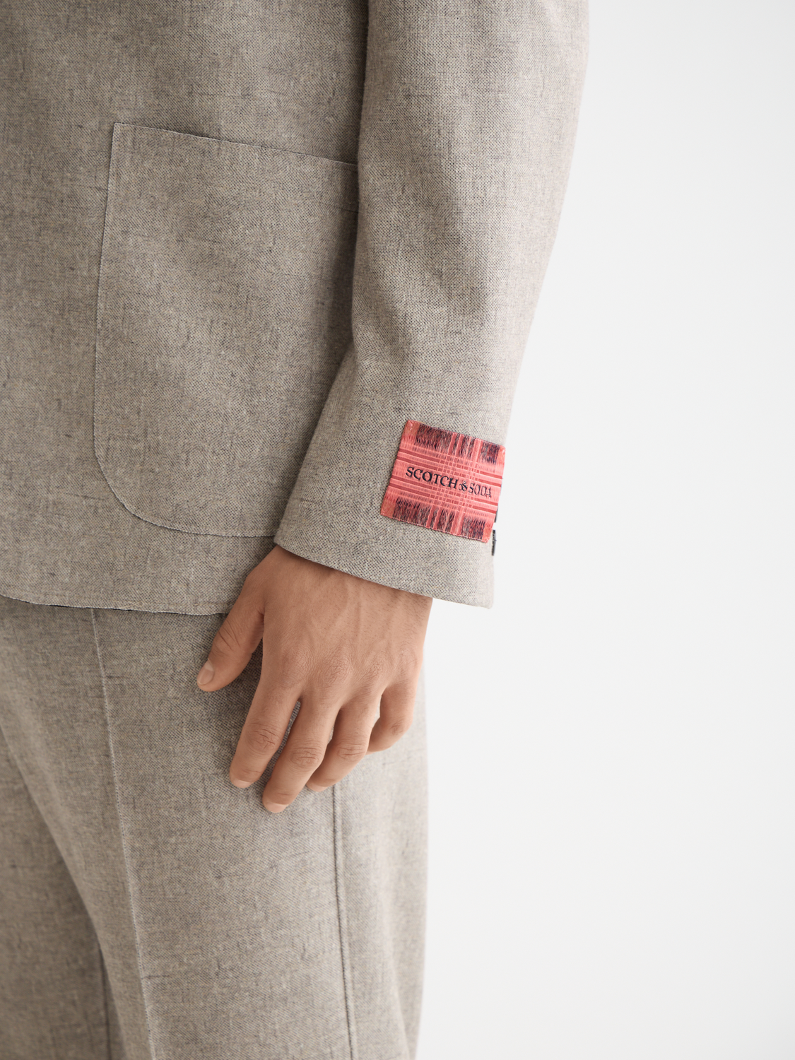 Unconstructed Scotch & Soda blazer in neutral fabric, showing its tailored collar and lapels on a plain background.