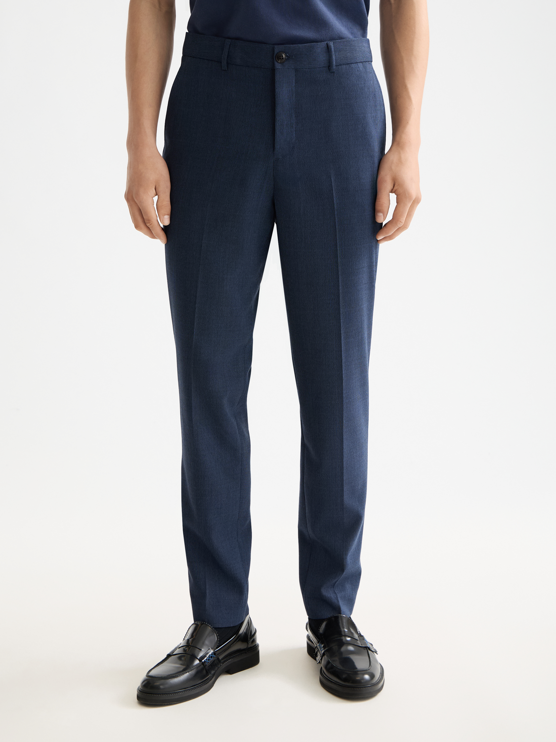 Scotch & Soda Irving tapered chinos in a dark color, showing the fit and fabric texture of the men's pants.