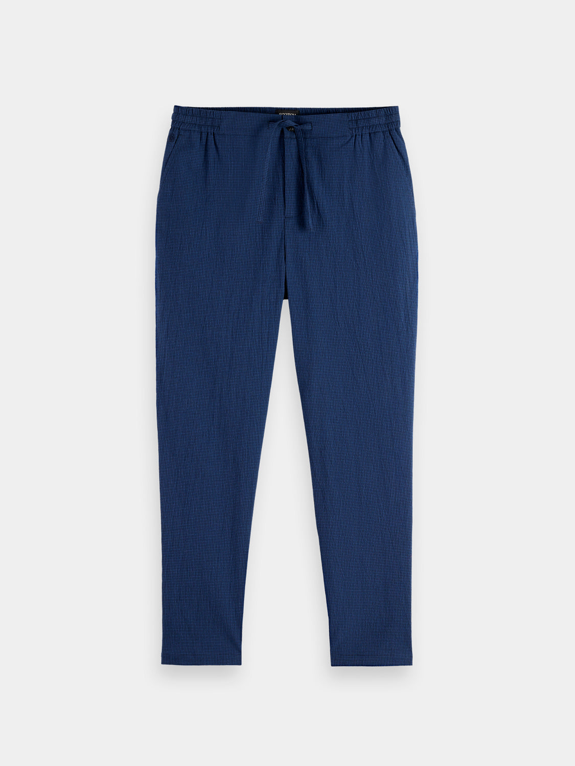SCOTCH & SODA Finch tapered-fit pants in neutral fabric, shown on a model with a casual style and classic design.