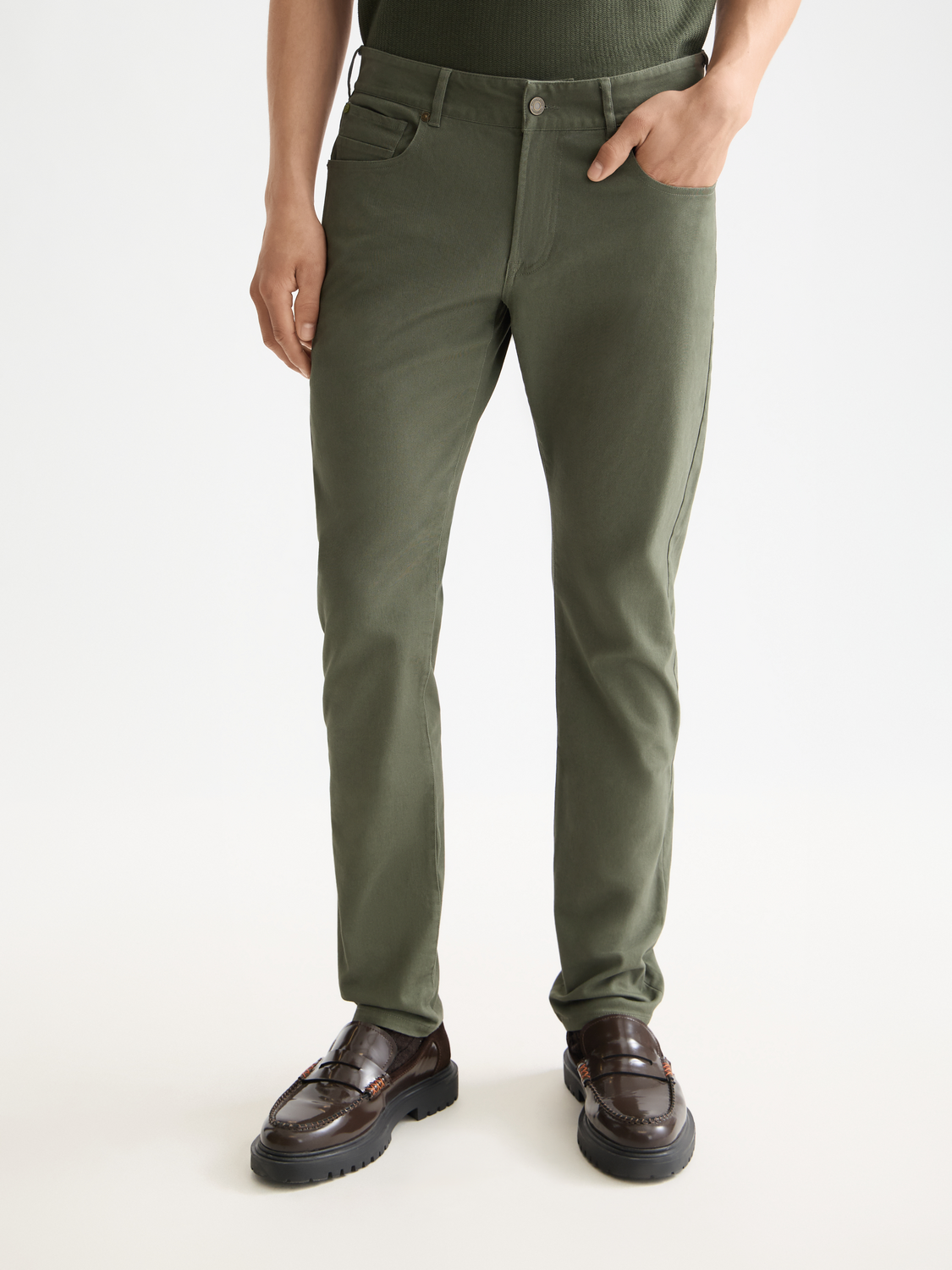 Slim-fit Ralston 5-pocket pants by Scotch & Soda, shown in dark denim with front and back pockets.