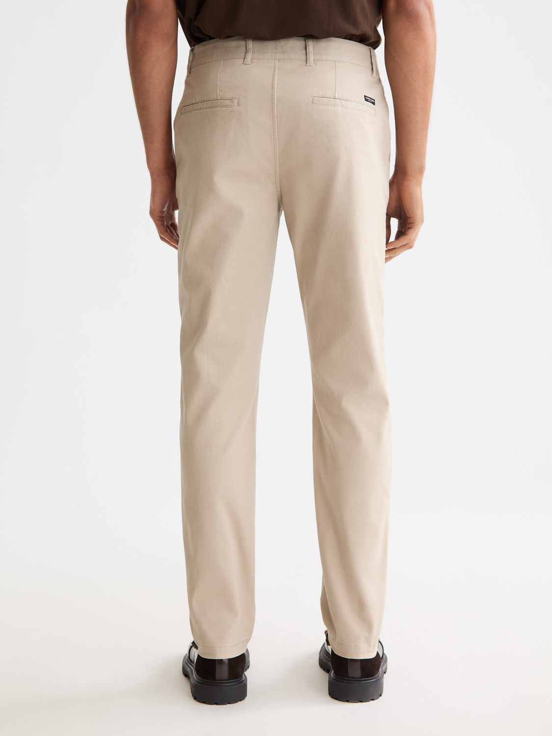 Stuart slim-fit chinos by Scotch & Soda, front view showing beige casual pants with a tailored fit and belt loops.
