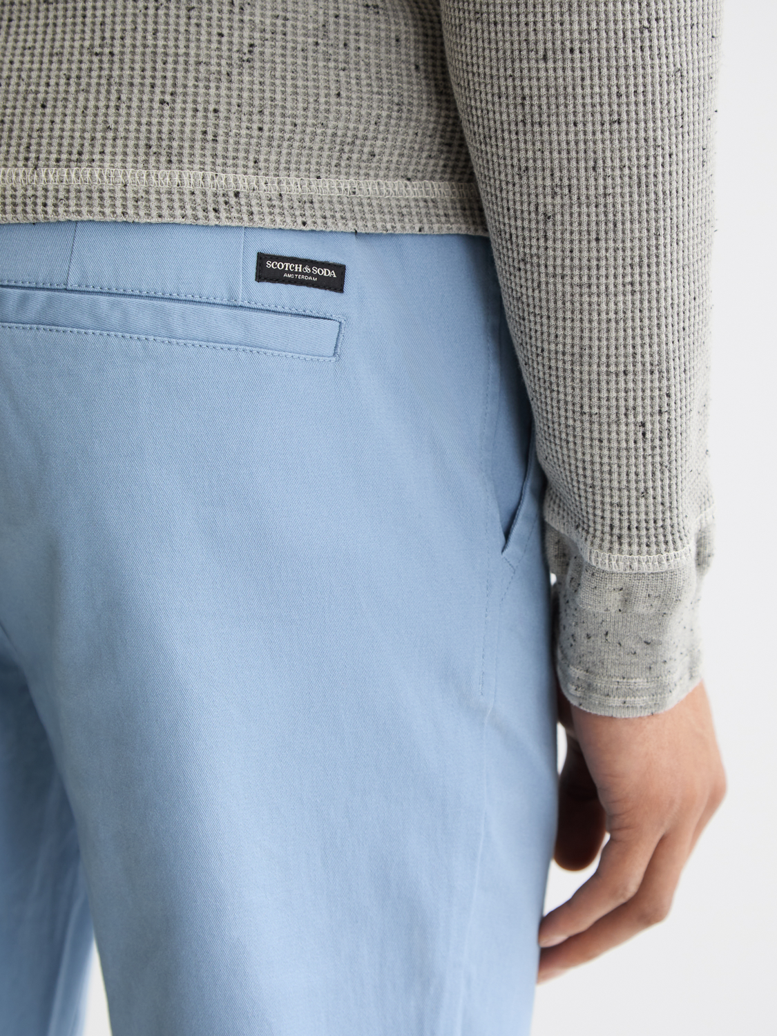 Slim-fit Mott chinos by Scotch & Soda, showing the beige pants with a tailored fit and classic five-pocket design.