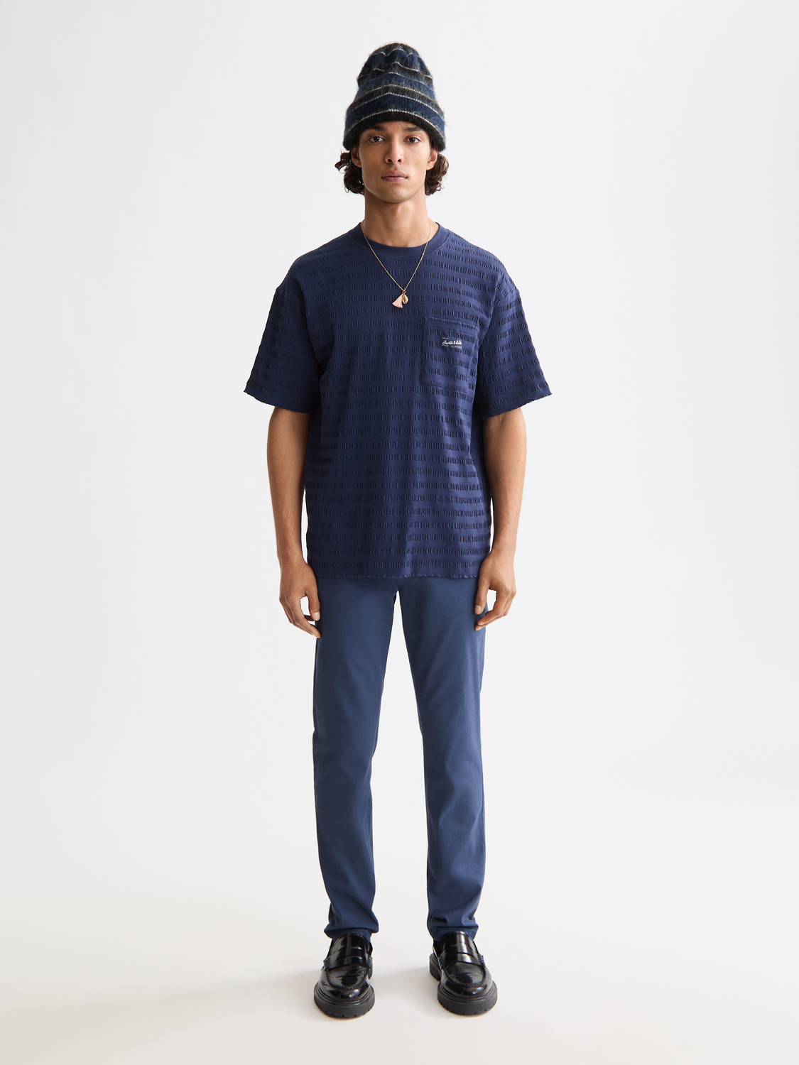 Slim-fit Mott chinos by Scotch & Soda displayed on a model, showcasing the stylish beige pants with a tailored fit.