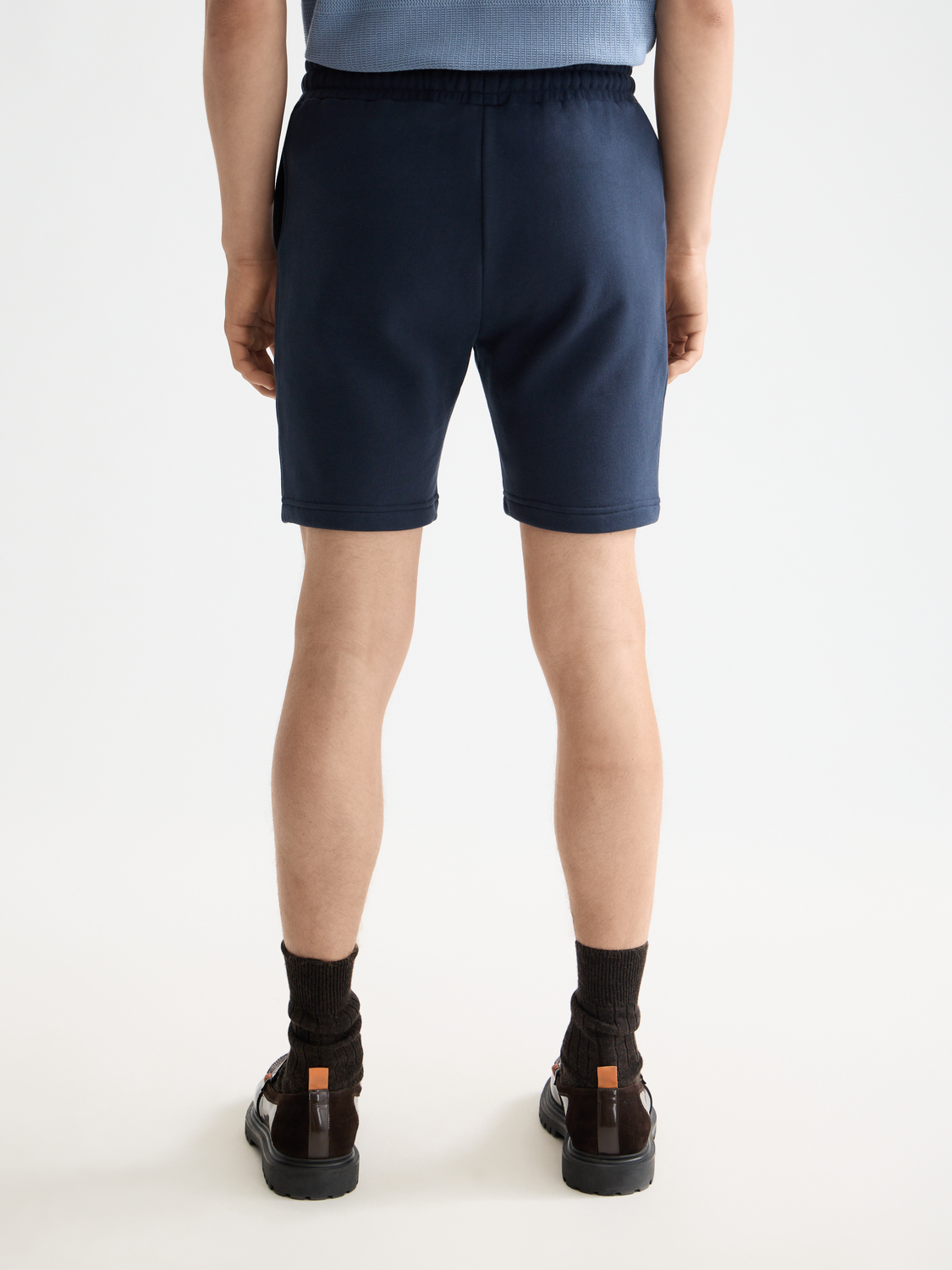 Black logo badge sweatshorts by Scotch & Soda with front and back view, casual athletic shorts with branded logo detail.