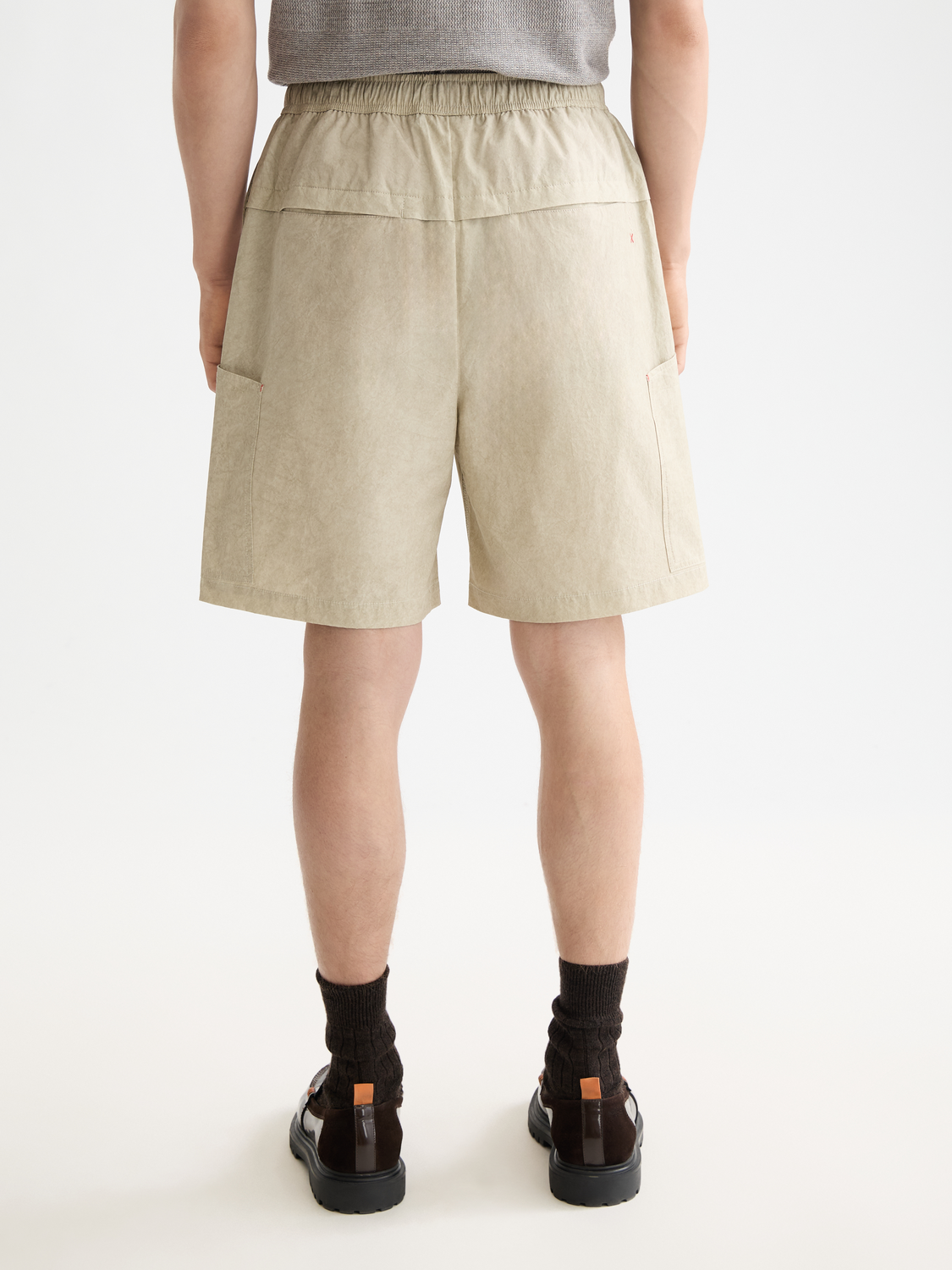Scotch & Soda cargo shorts with multiple pockets, shown from the back, made of lightweight fabric for casual summer wear.