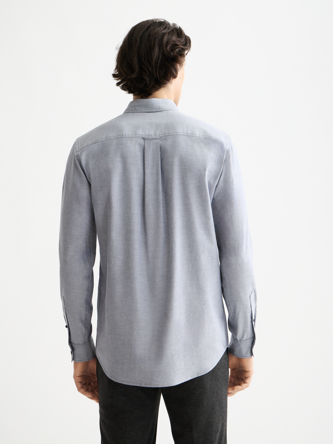 Long-sleeve Oxford shirt by Scotch & Soda in light blue, showing the back view with collar and button details.