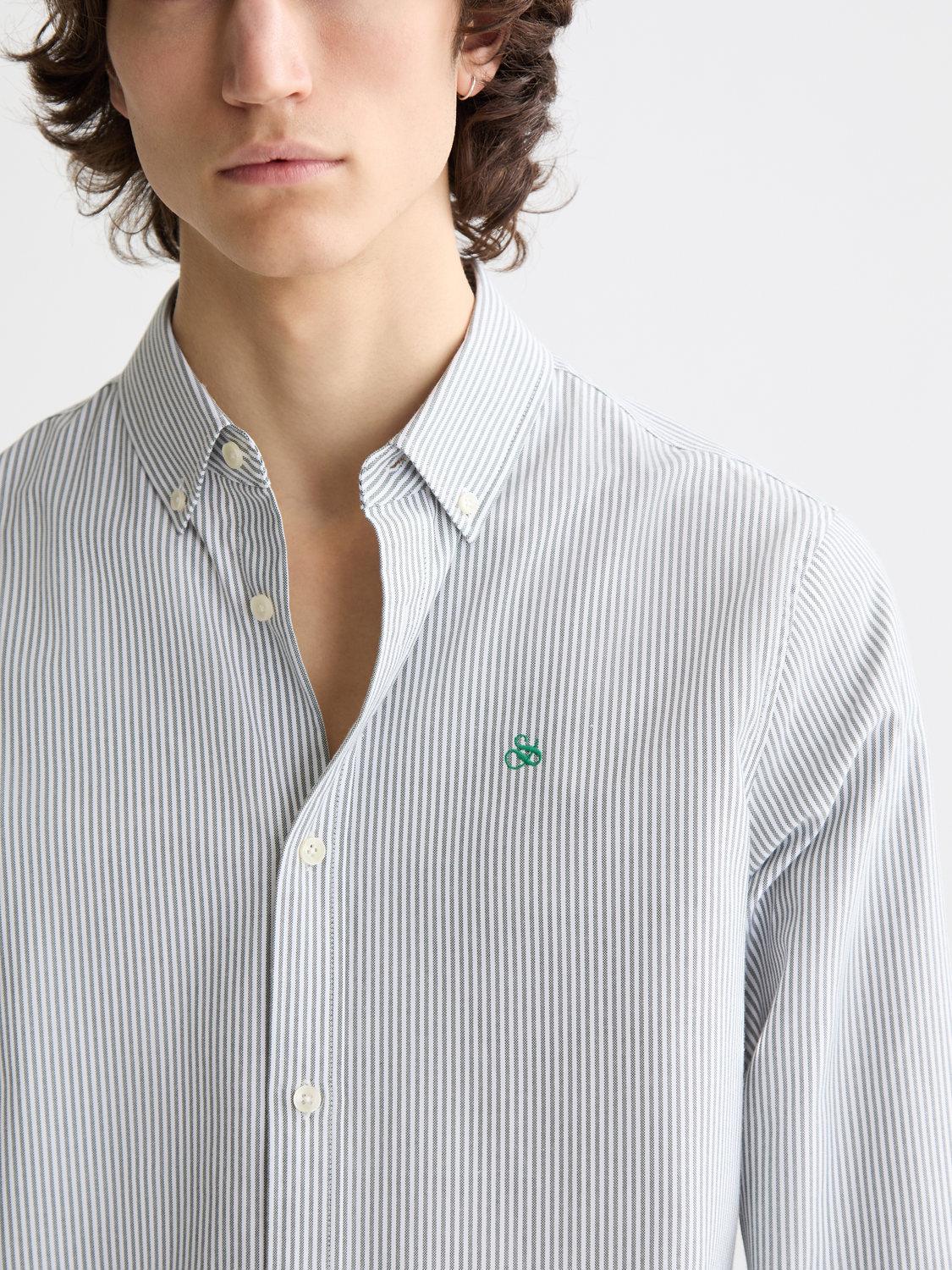 Long sleeve striped Oxford shirt by Scotch & Soda with blue, white, and red vertical stripes, button-down collar, and chest pocket.
