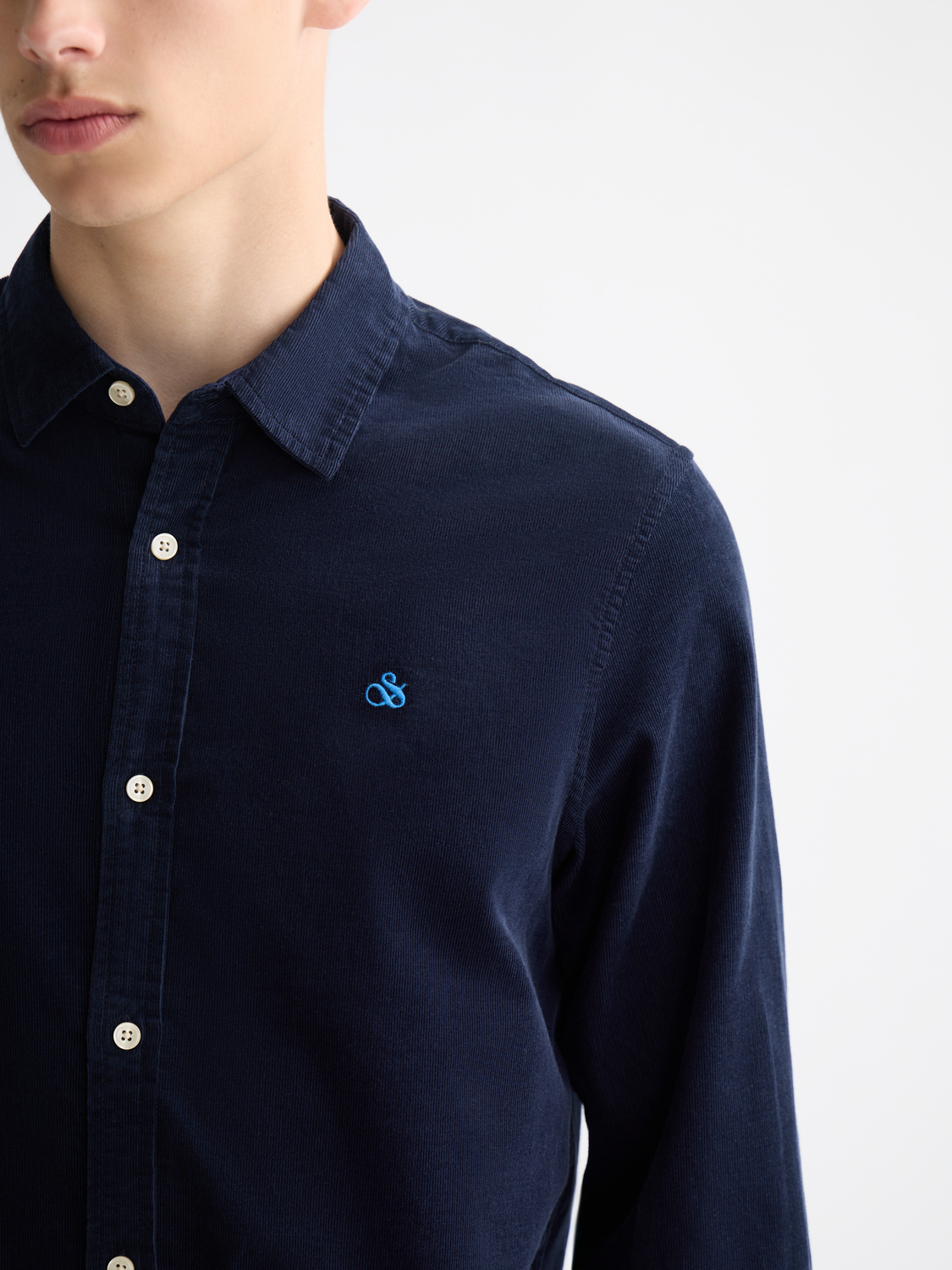 Long-sleeve Scotch & Soda corduroy shirt in a stylish design, showing the textured fabric and button details.