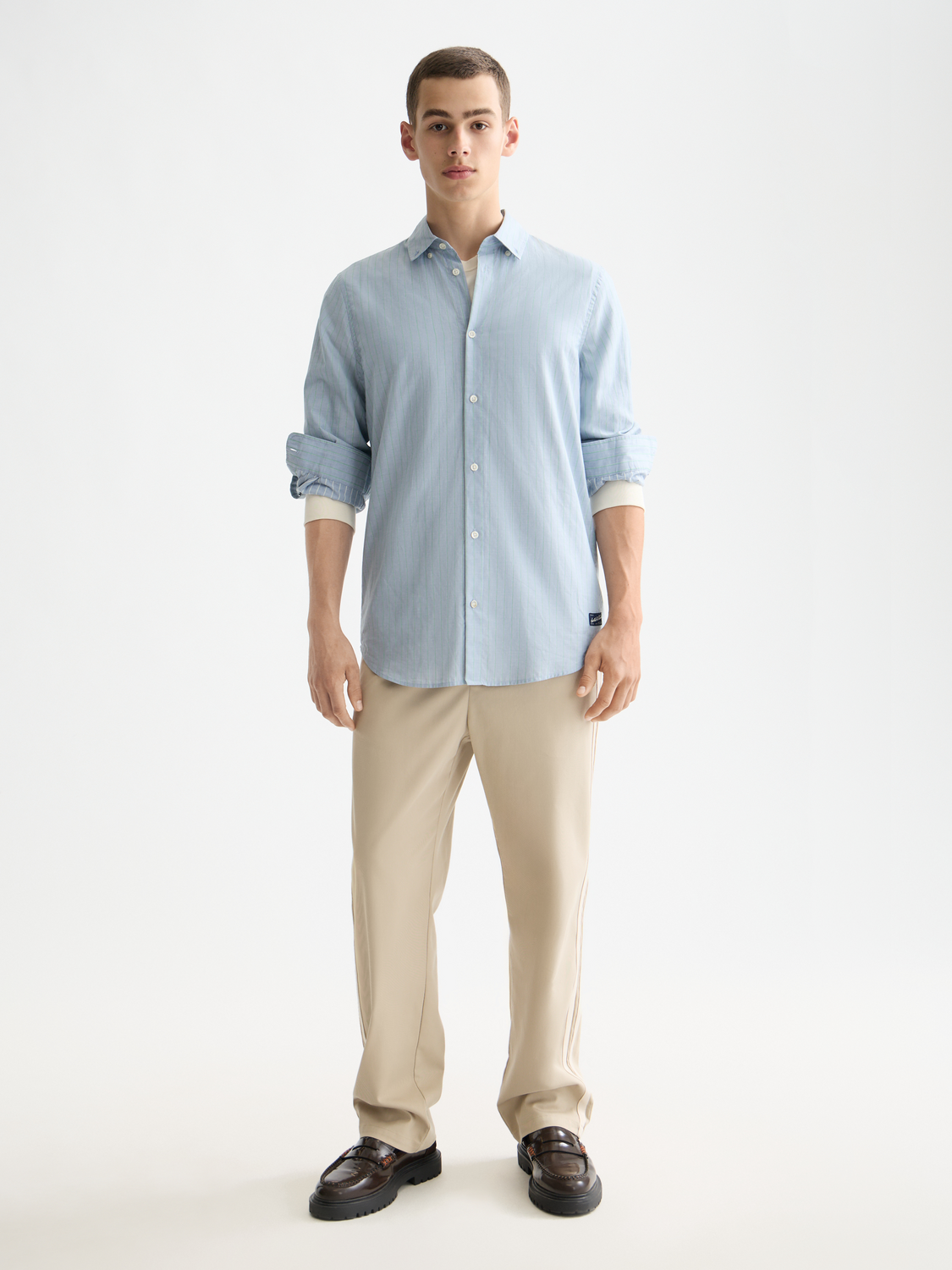 Yarn-dyed striped long sleeve shirt by Scotch & Soda, featuring a classic pattern and buttoned collar, displayed on a mannequin.