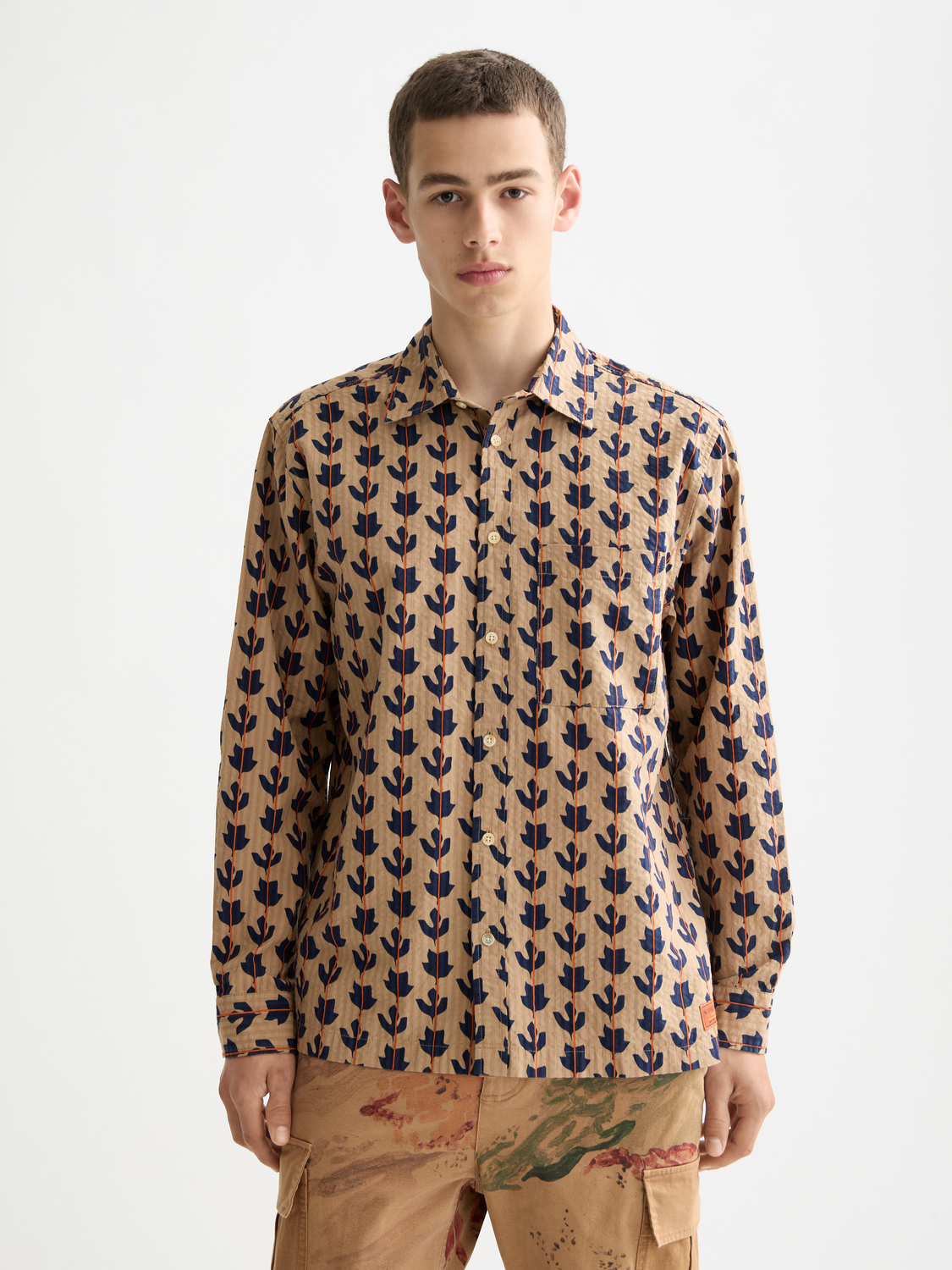 Long-sleeve printed shirt by Scotch & Soda featuring vibrant patterns and a relaxed fit, displayed on a hanger.