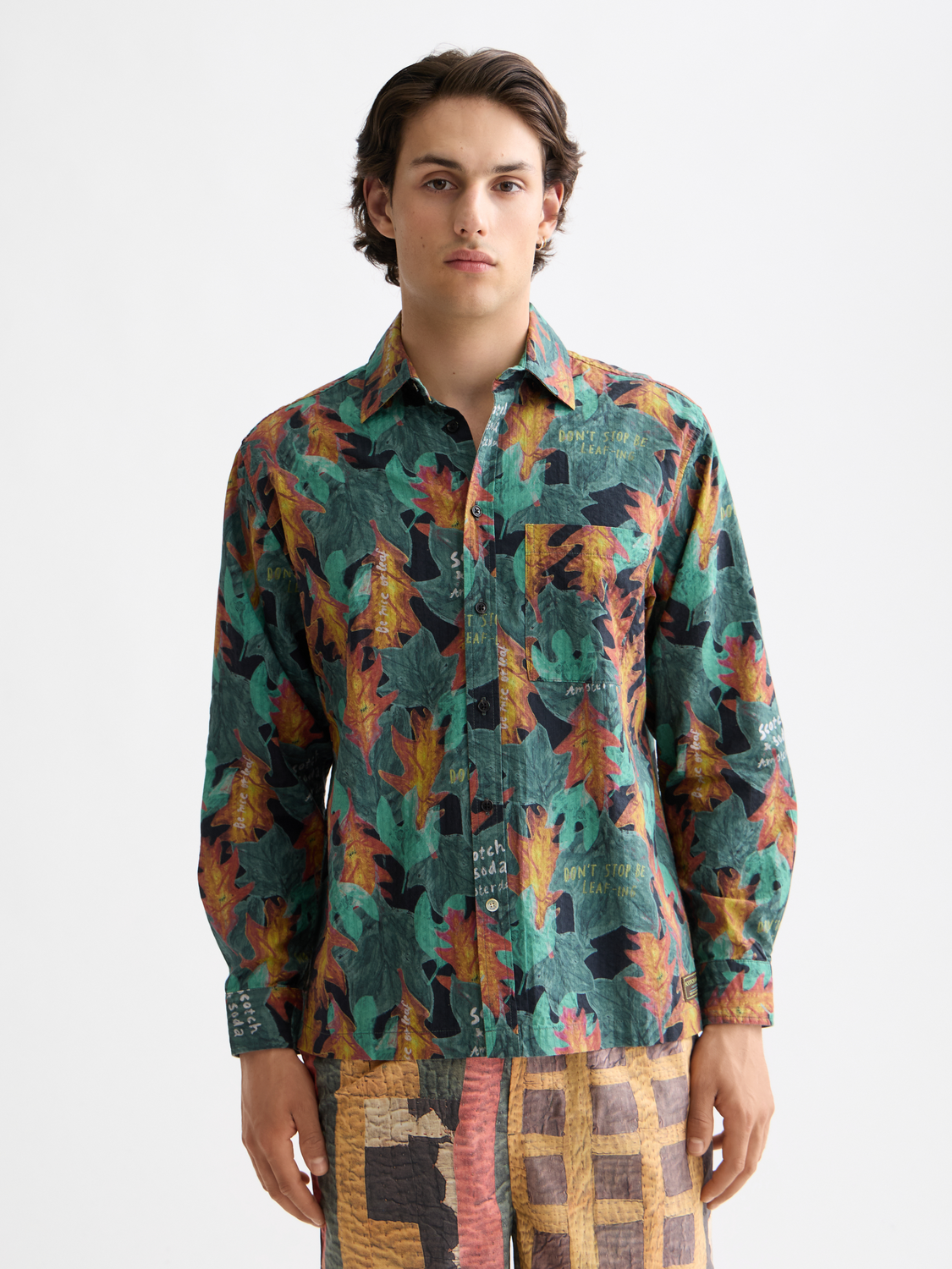 Long-sleeve printed shirt by Scotch & Soda featuring a vibrant pattern, displayed on a hanger against a neutral background.