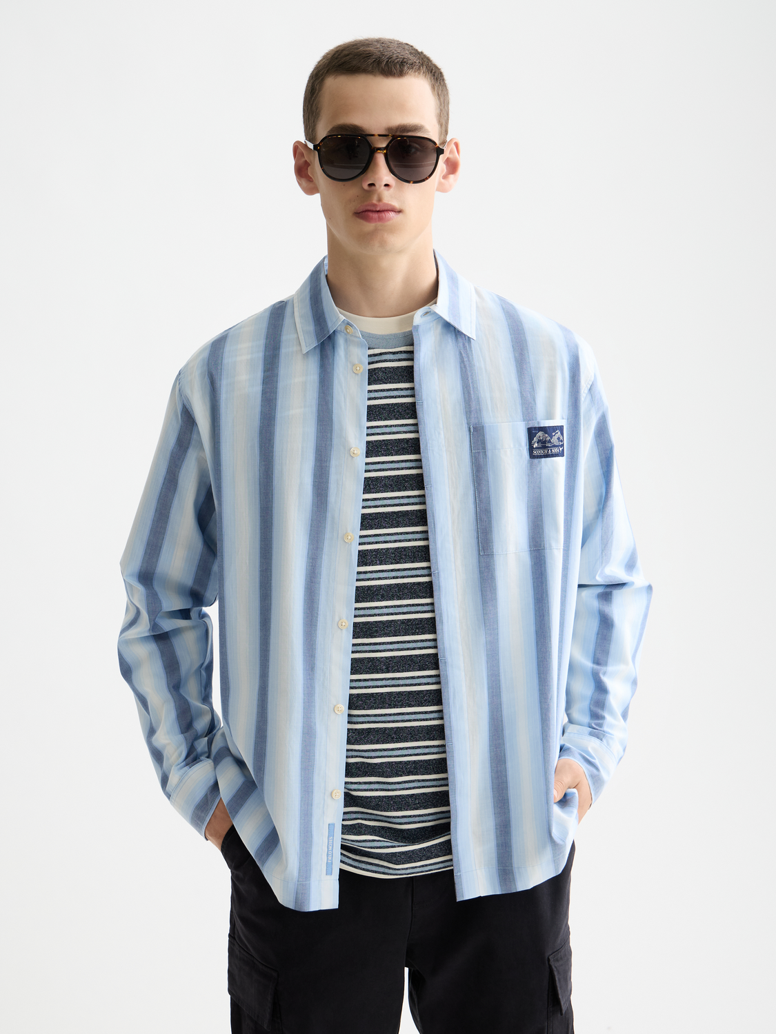 Long sleeve striped shirt by Scotch & Soda, featuring a classic pattern and button-up front, displayed on a hanger.