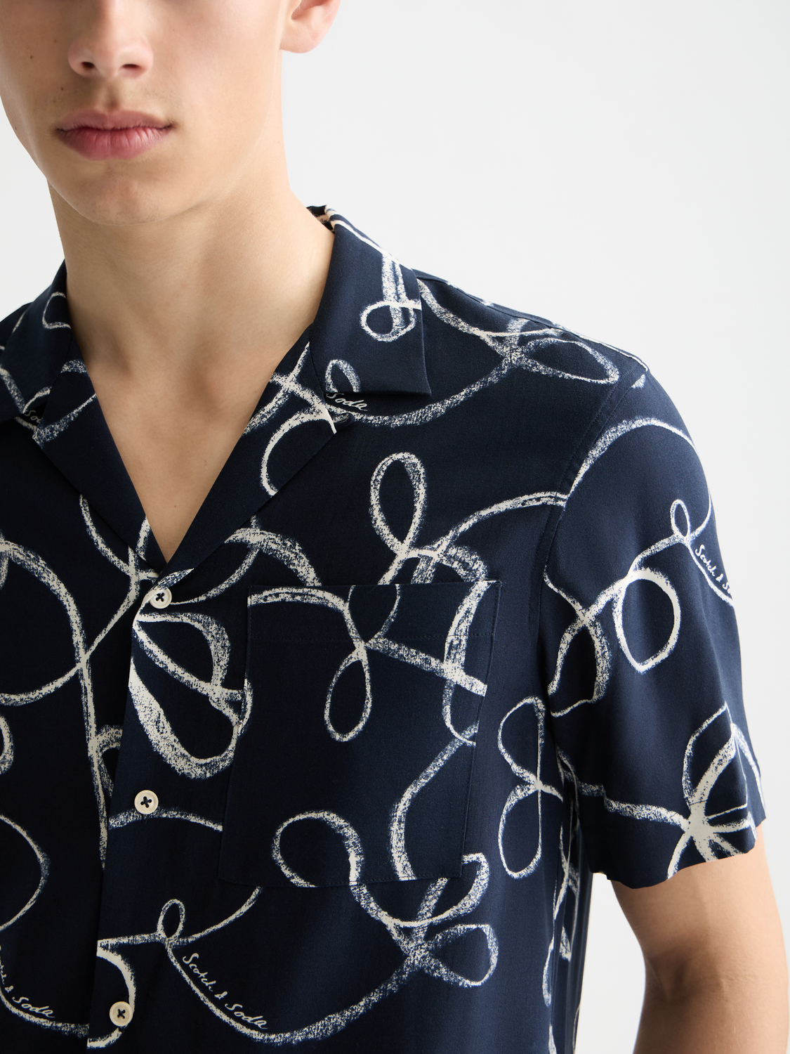 Printed Scotch & Soda short-sleeved shirt with vibrant floral pattern on lightweight fabric.