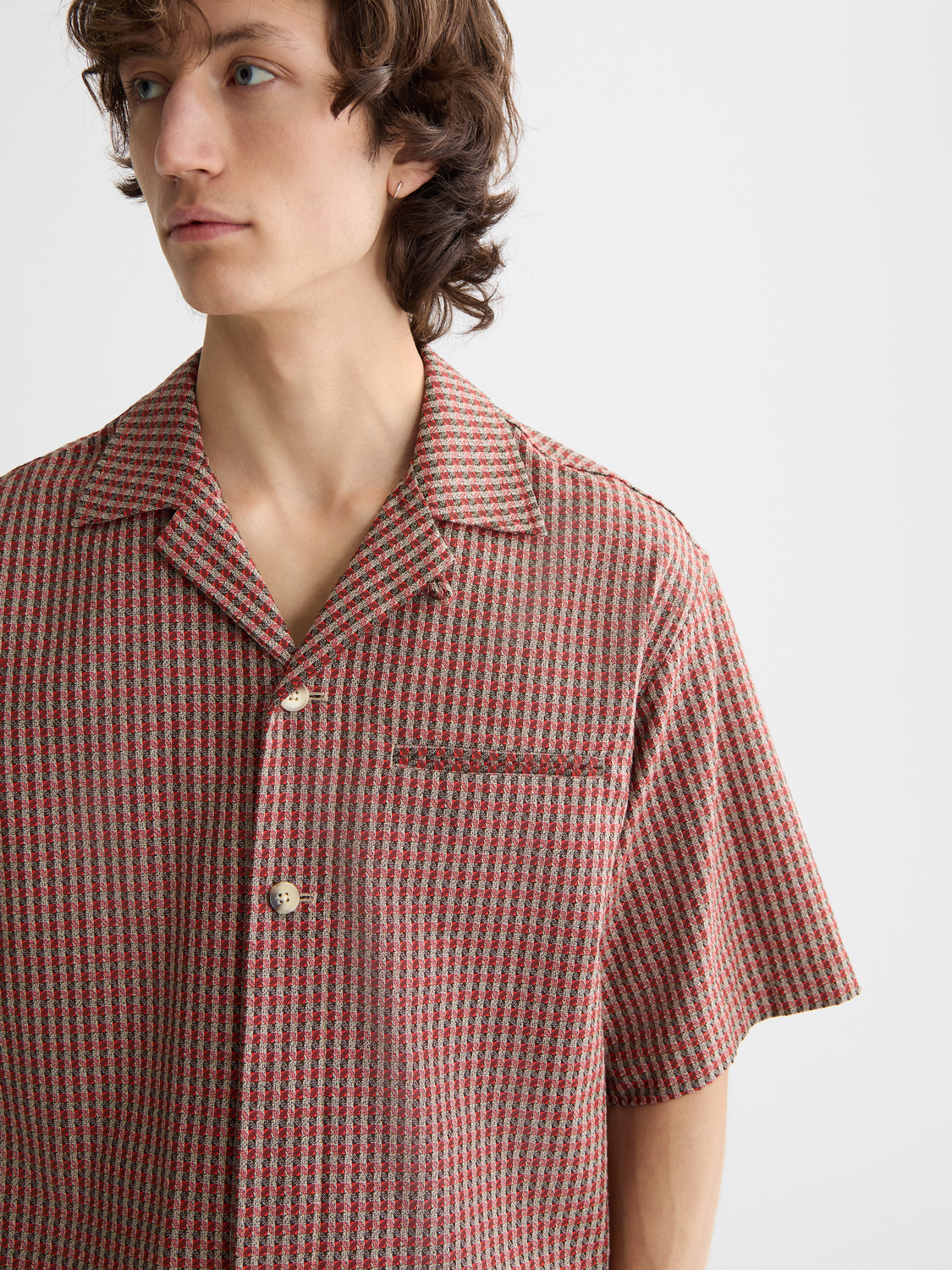 Printed short-sleeved shirt by Scotch & Soda, featuring vibrant patterns and a casual fit, displayed on a model.