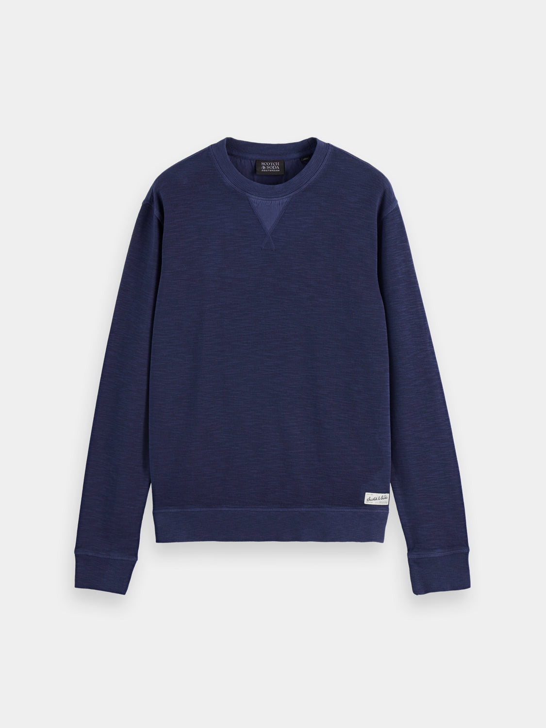 Garment-dyed sweatshirt by Scotch & Soda, soft fabric with a relaxed fit, shown in a casual style on a model.