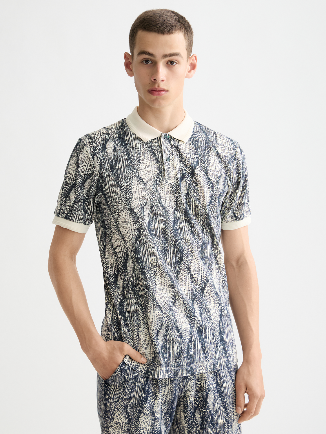 Printed Scotch & Soda polo shirt with a colorful pattern, short sleeves, and a classic collar.