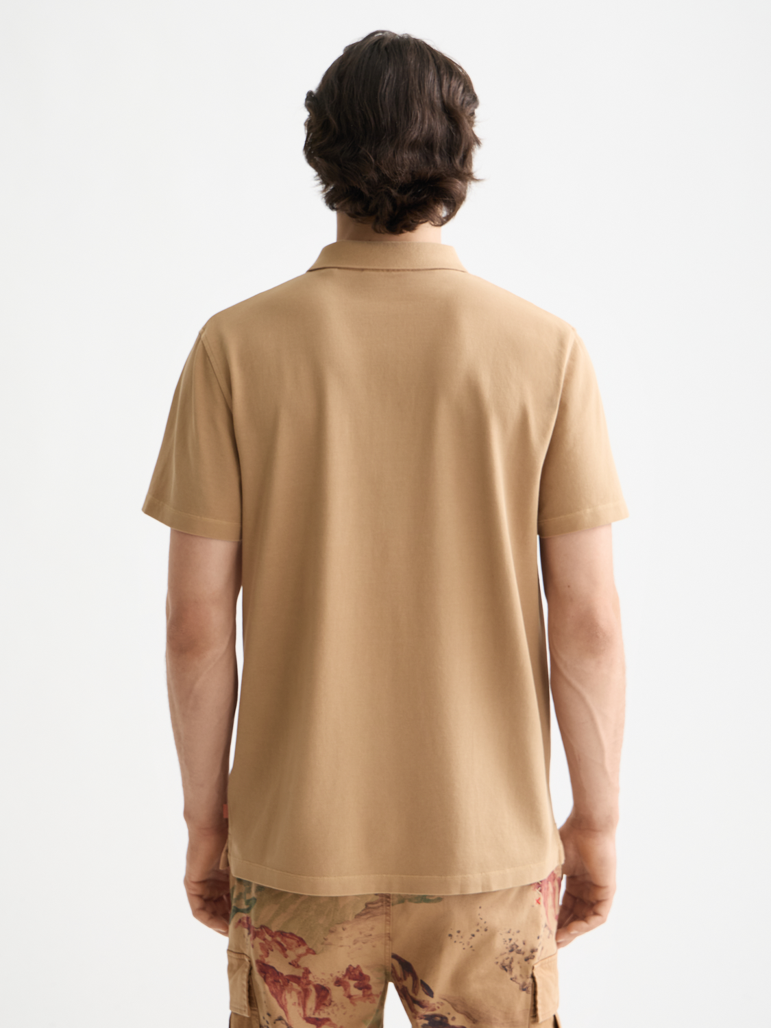 Blue Scotch & Soda pique polo shirt with collar and short sleeves, displayed on a hanger.