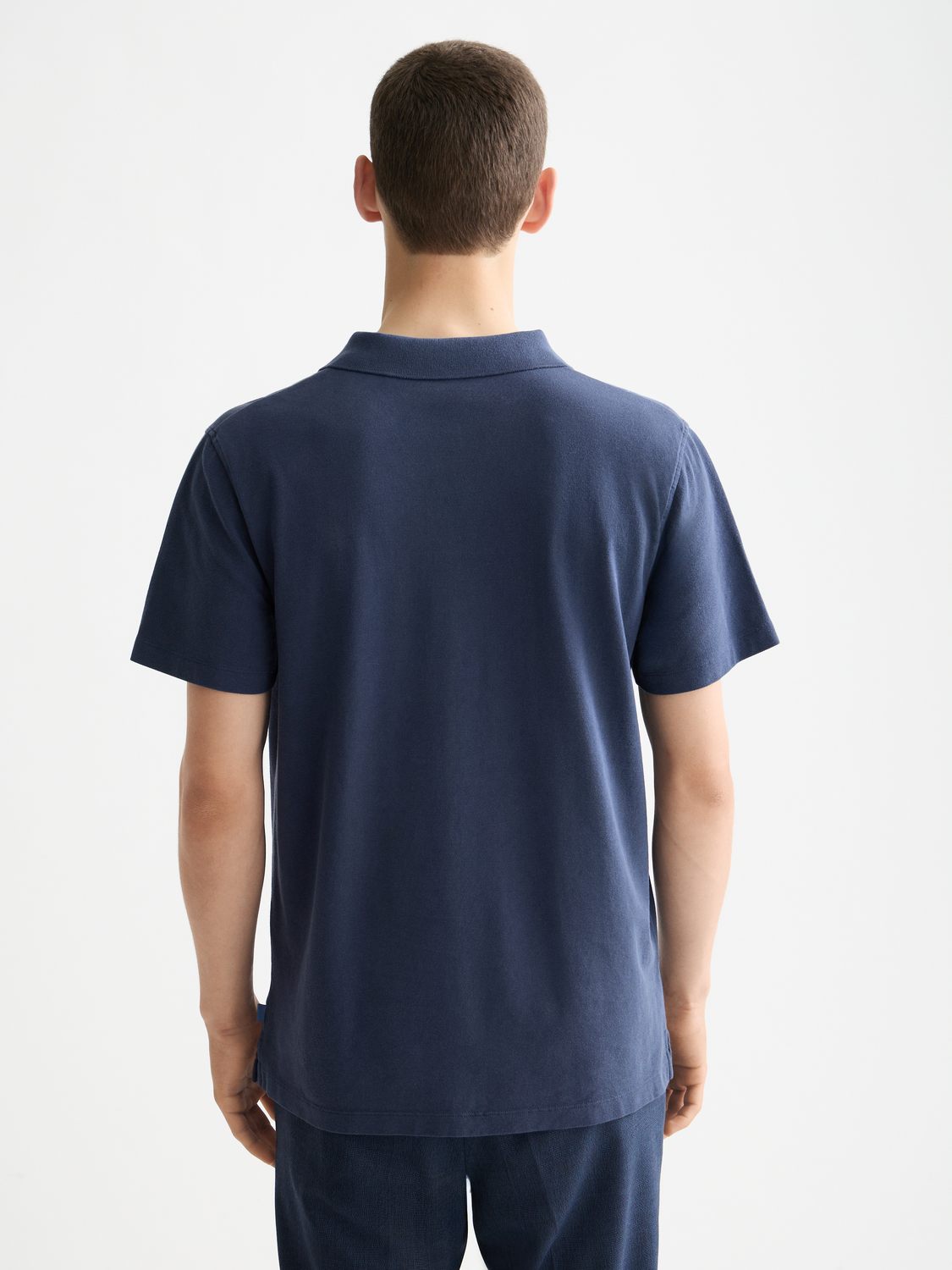 Navy Scotch & Soda pique polo shirt with a classic collar and short sleeves, displayed from the back.