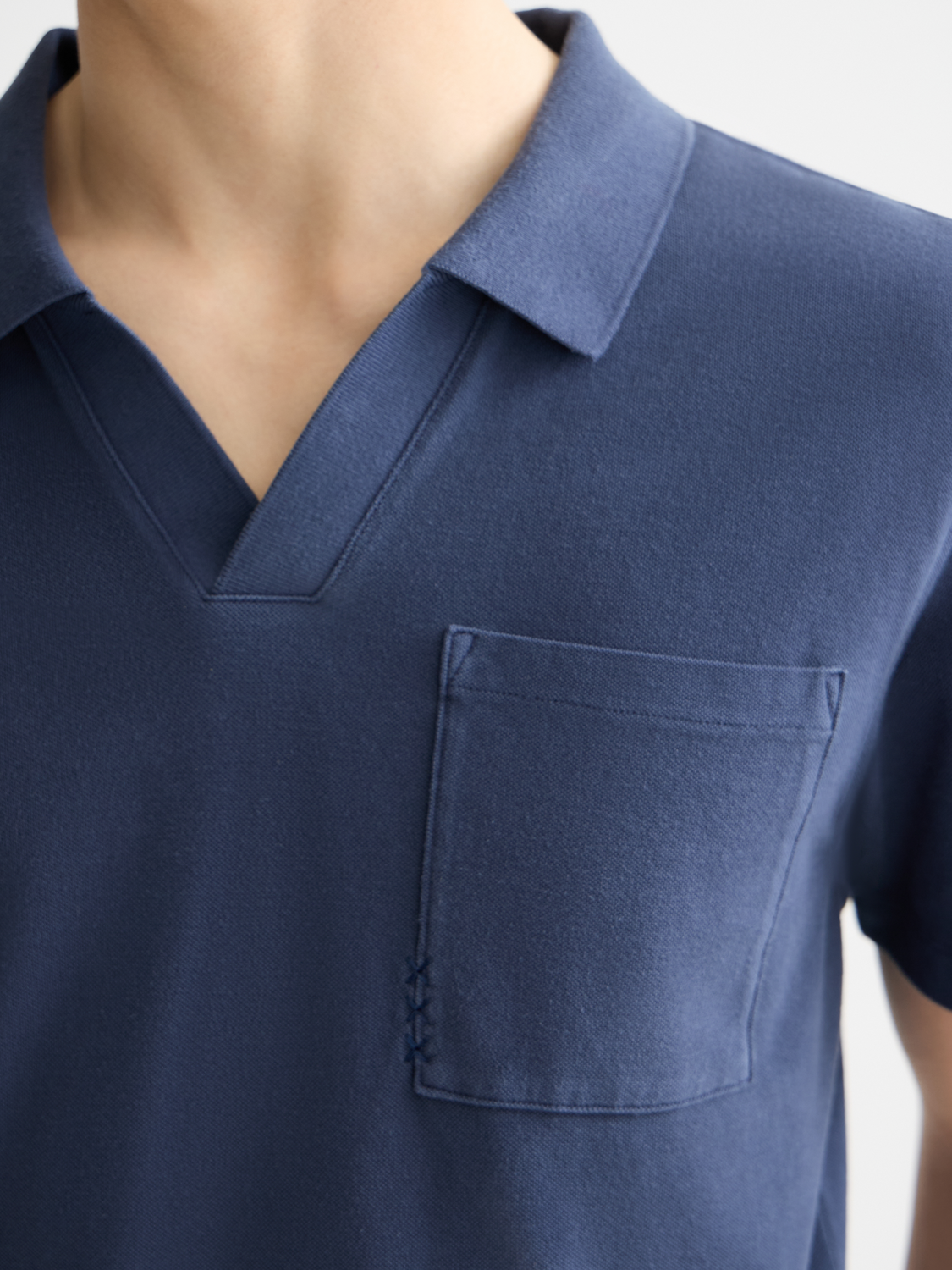 Scotch & Soda pique polo shirt in navy with a classic collar and short sleeves, displayed flat on a white background.