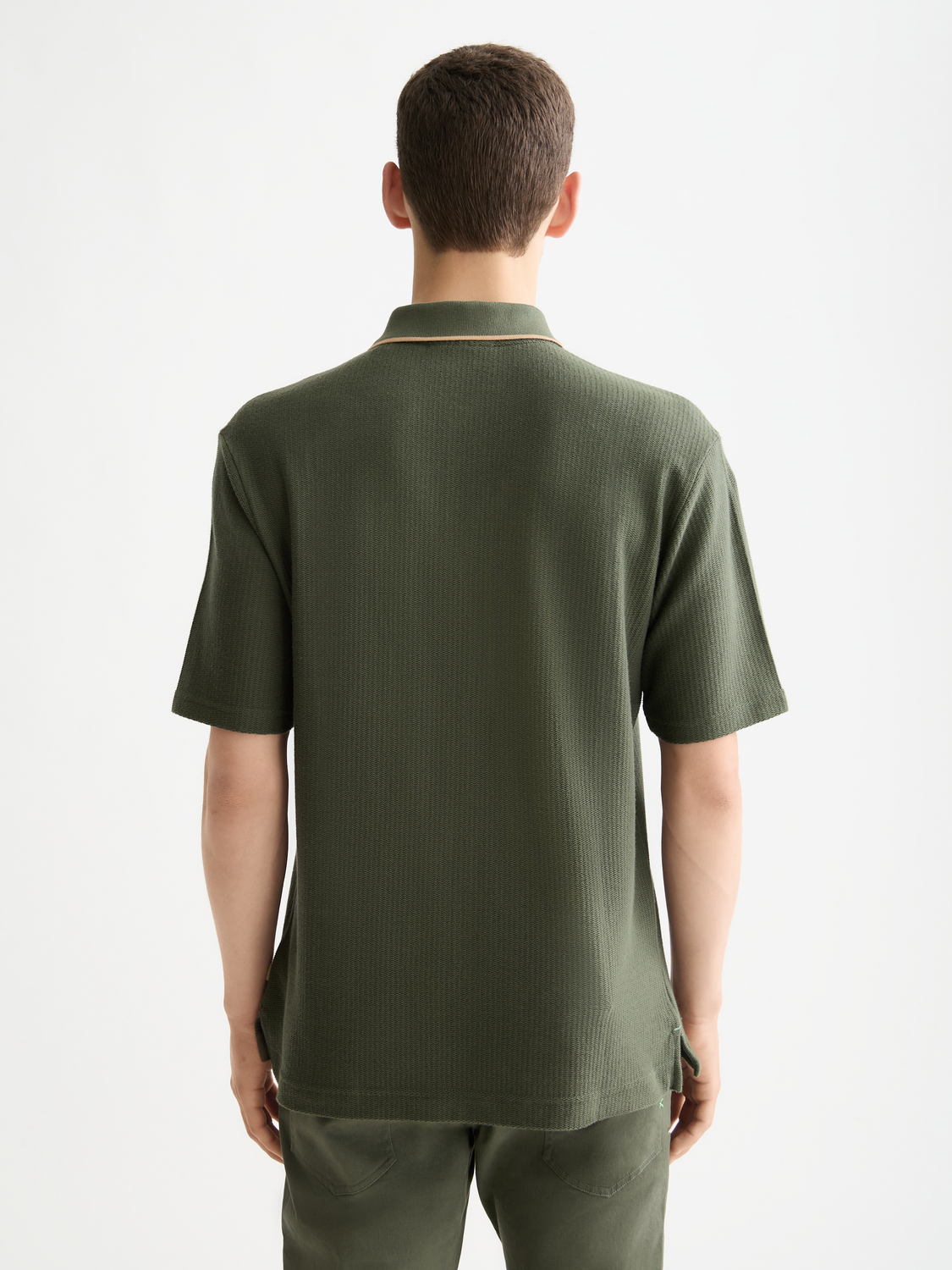 Structured black polo shirt by Scotch & Soda, featuring a classic fit and collar, displayed on a hanger.