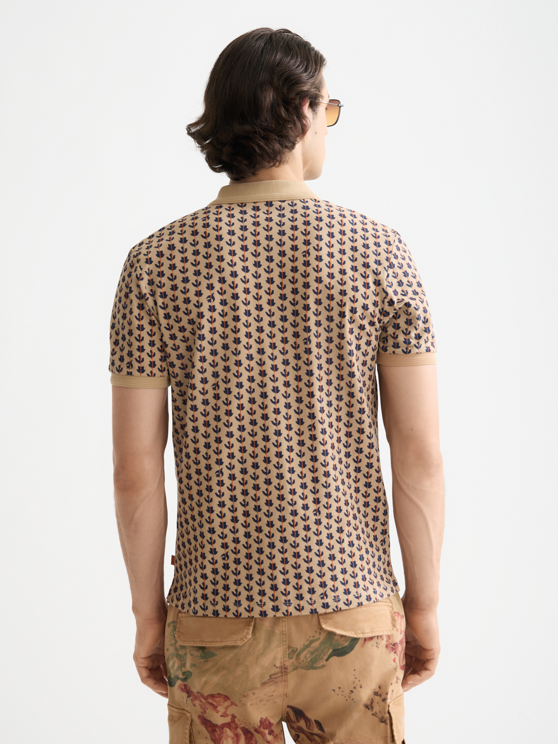 Printed Scotch & Soda polo shirt with colorful pattern, front view showing collar and button placket.