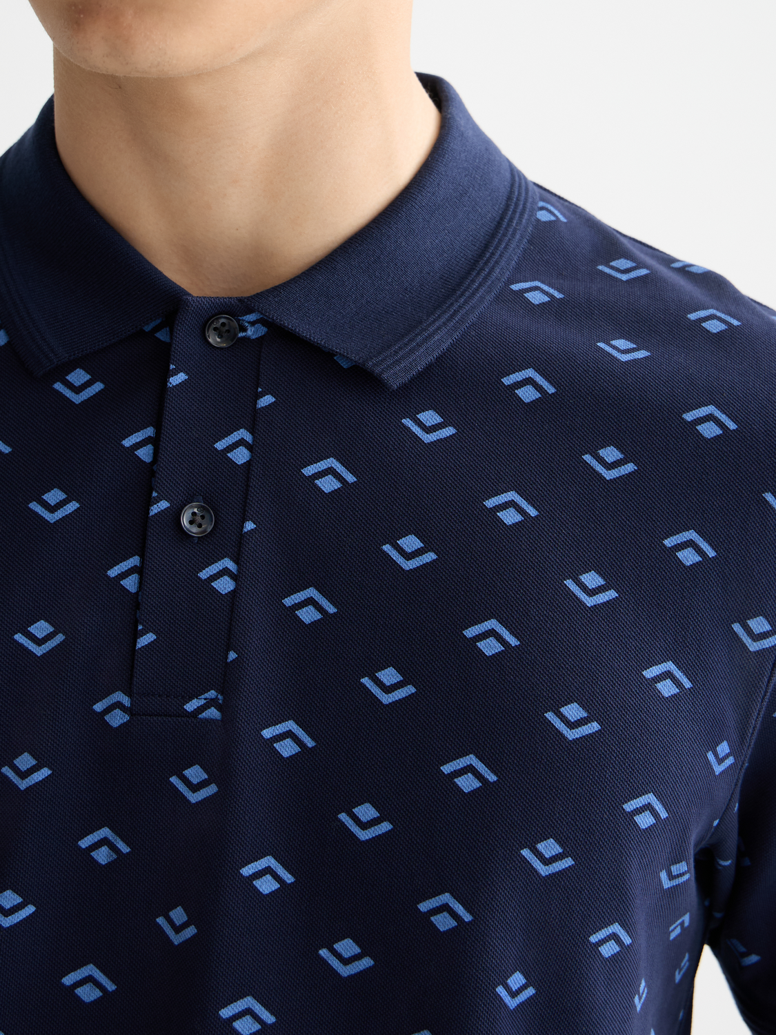 Printed Scotch & Soda polo shirt with colorful pattern, classic collar, and short sleeves, displayed on a plain background.