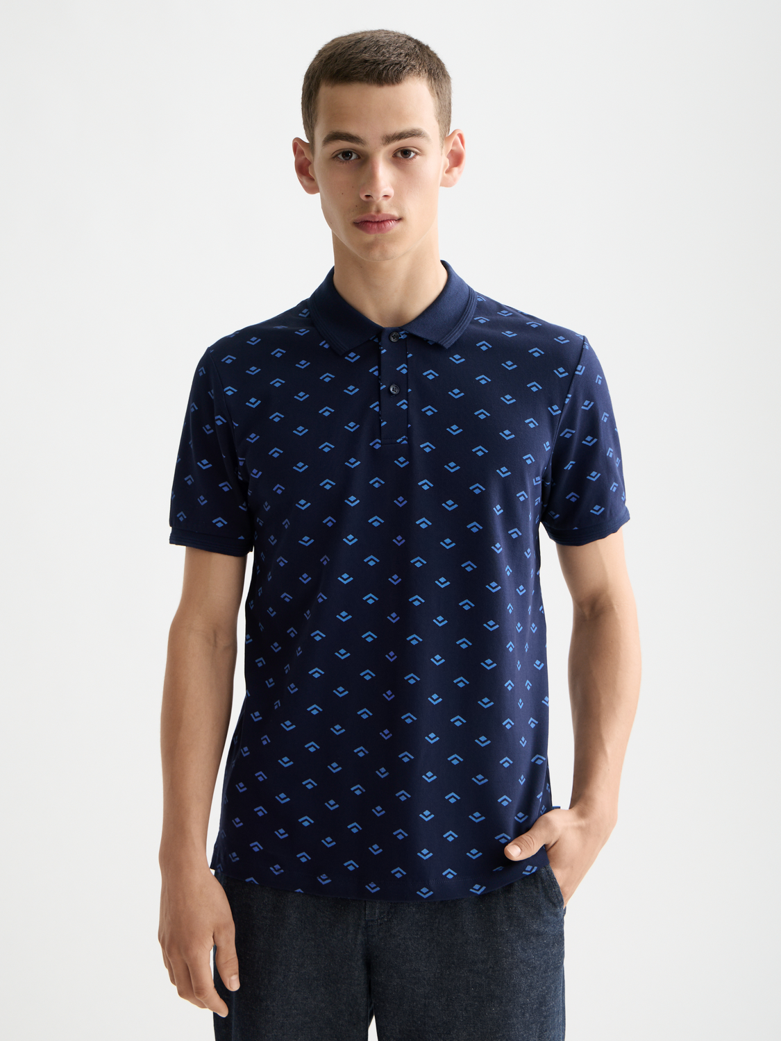 Printed Scotch & Soda polo shirt with vibrant floral design and classic collar, shown in front view.