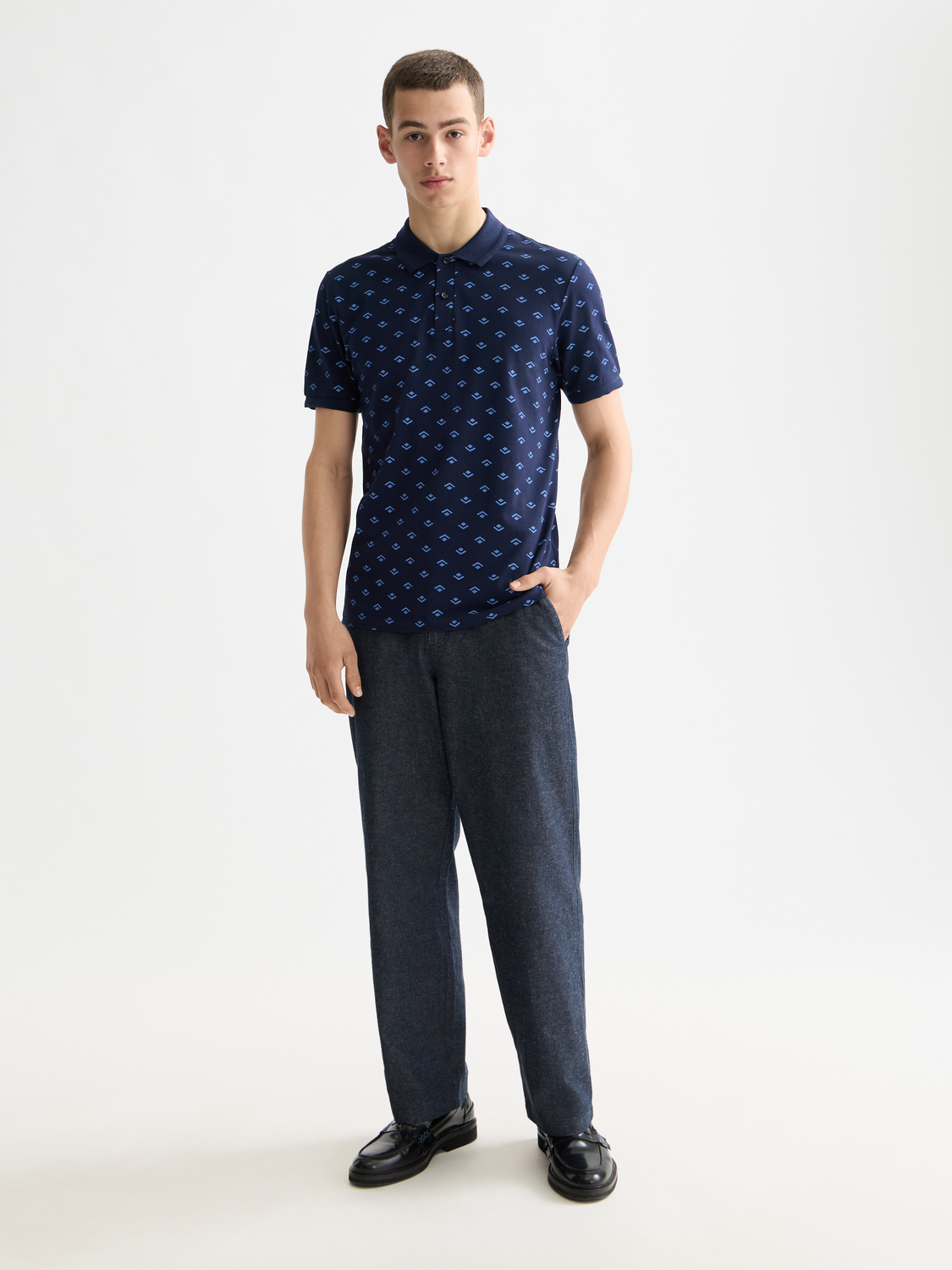 Printed Scotch & Soda polo shirt with colorful pattern, front view showing collar and short sleeves.