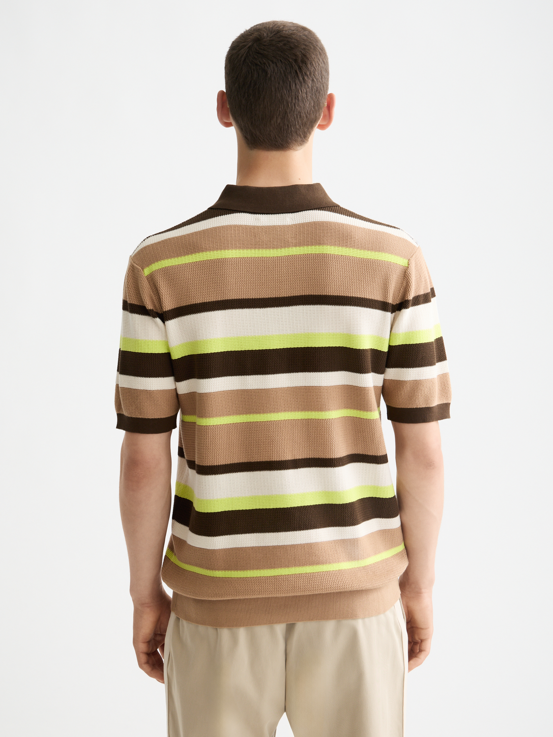 Knitted striped polo shirt from Scotch & Soda showing the back view with blue, white, and red horizontal stripes.