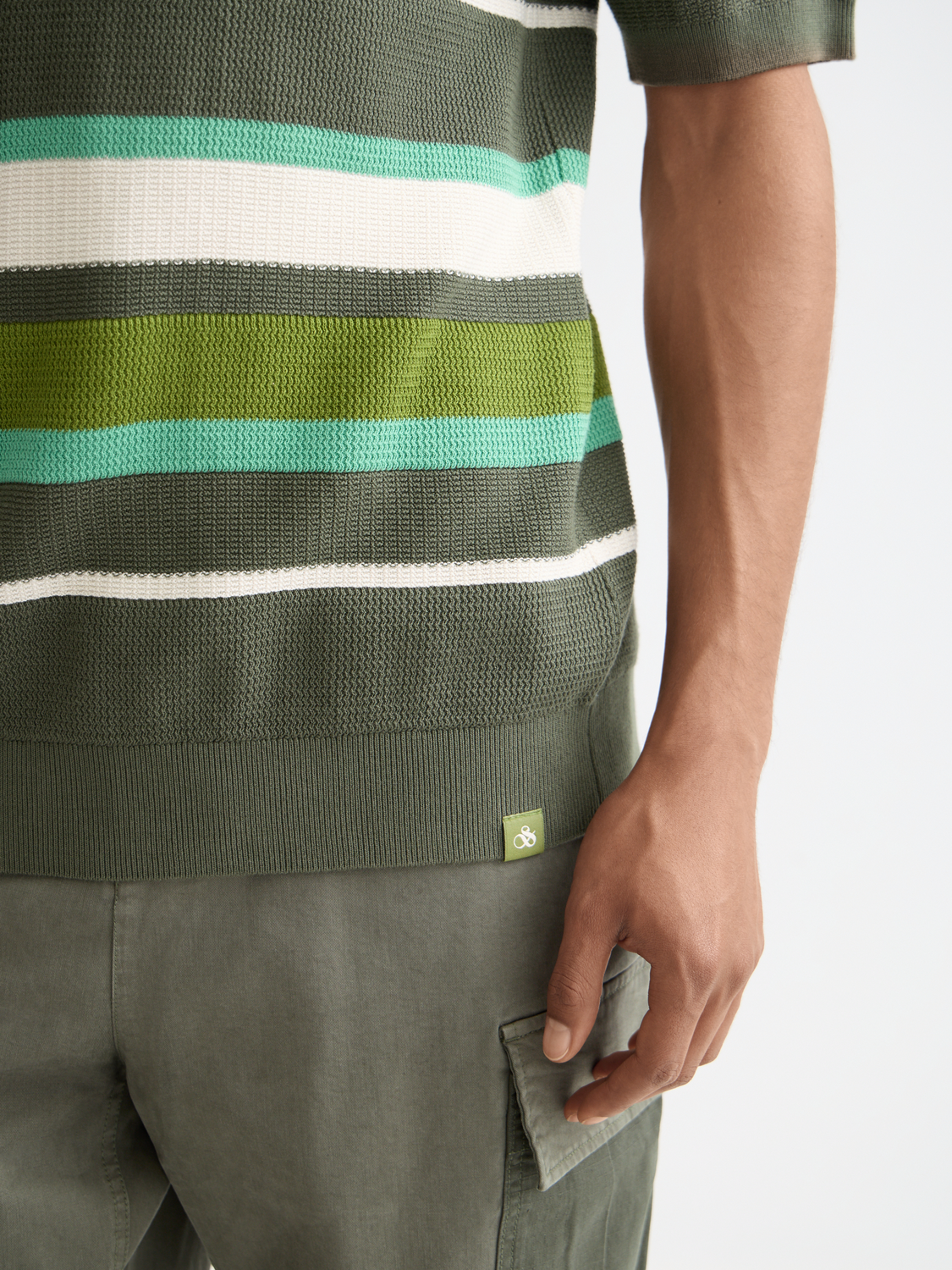 Knitted striped polo shirt from Scotch & Soda, featuring a classic collar and vibrant multicolor stripes.
