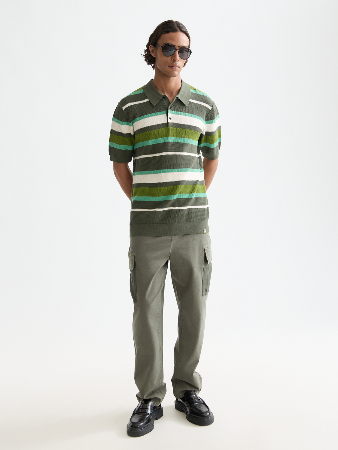 Blue and white striped knitted polo shirt by Scotch & Soda, featuring a classic collar and ribbed cuffs.
