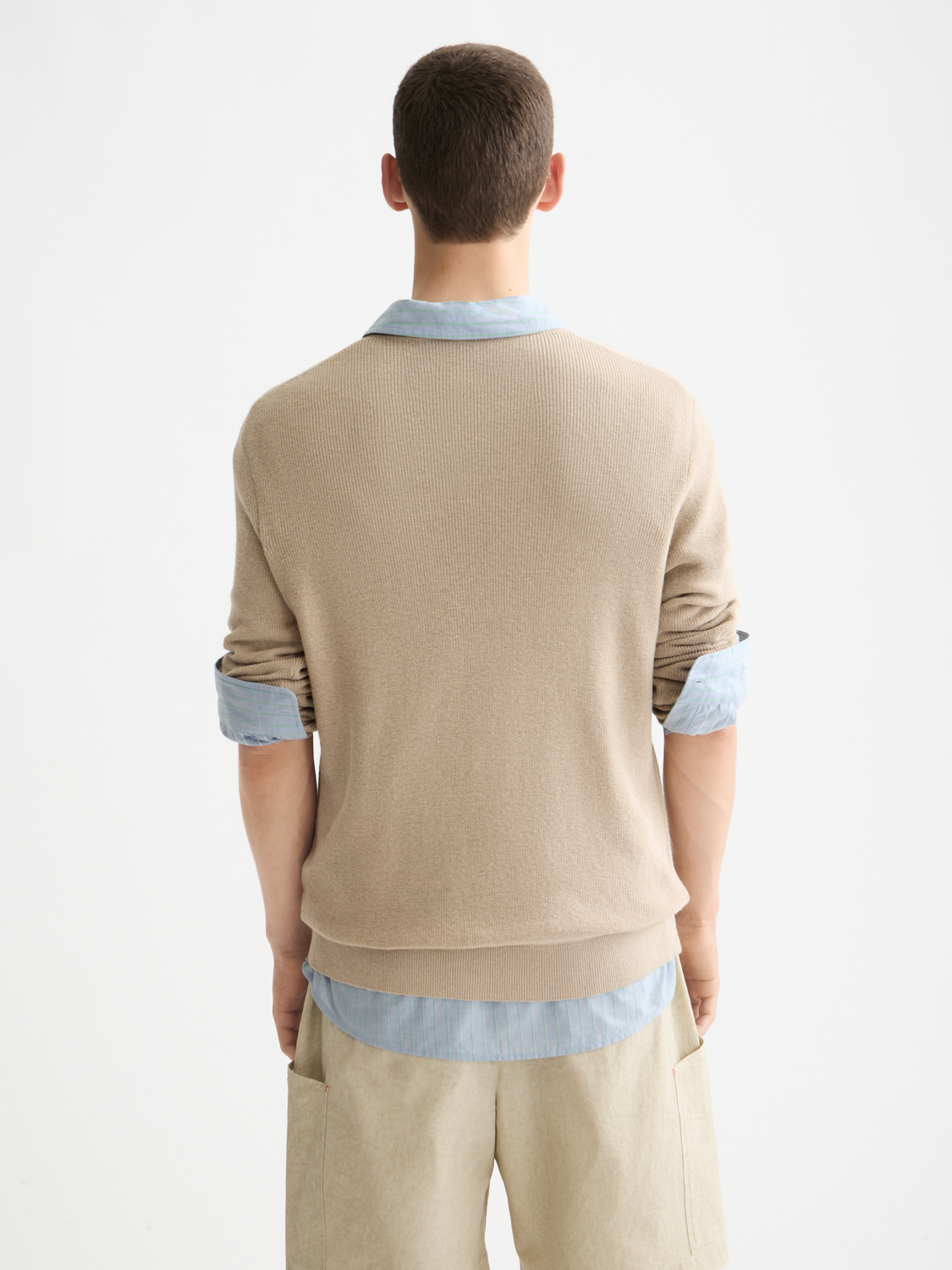 Black Scotch & Soda crewneck knitwear pullover displayed on a hanger, showcasing the classic crewneck design and soft fabric.