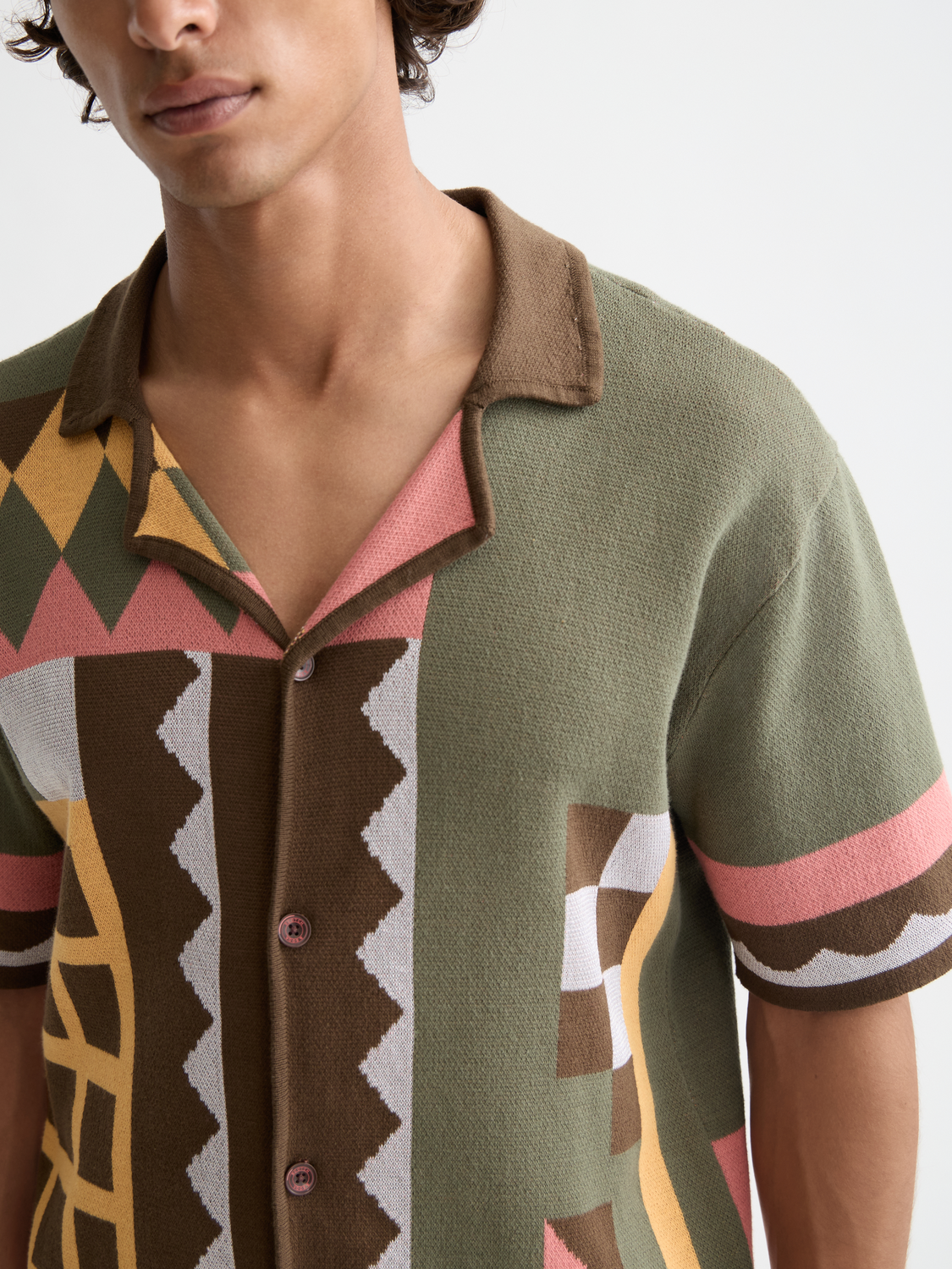Knitted short-sleeved shirt from Scotch & Soda, made of soft knitwear fabric, displayed flat with a textured pattern.