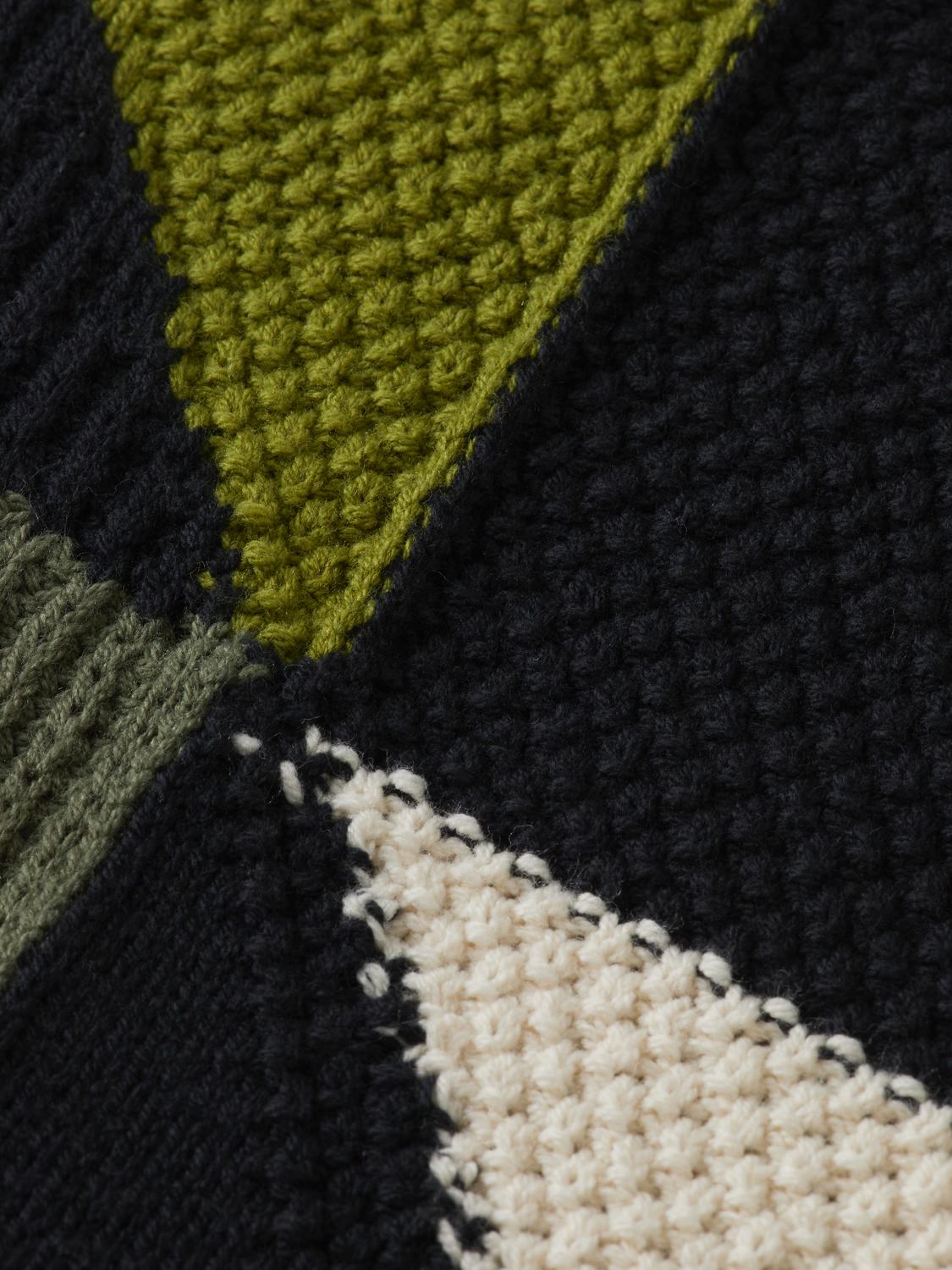 Patchwork long-sleeved knit polo shirt by Scotch & Soda featuring colorful patchwork pattern and classic collar.