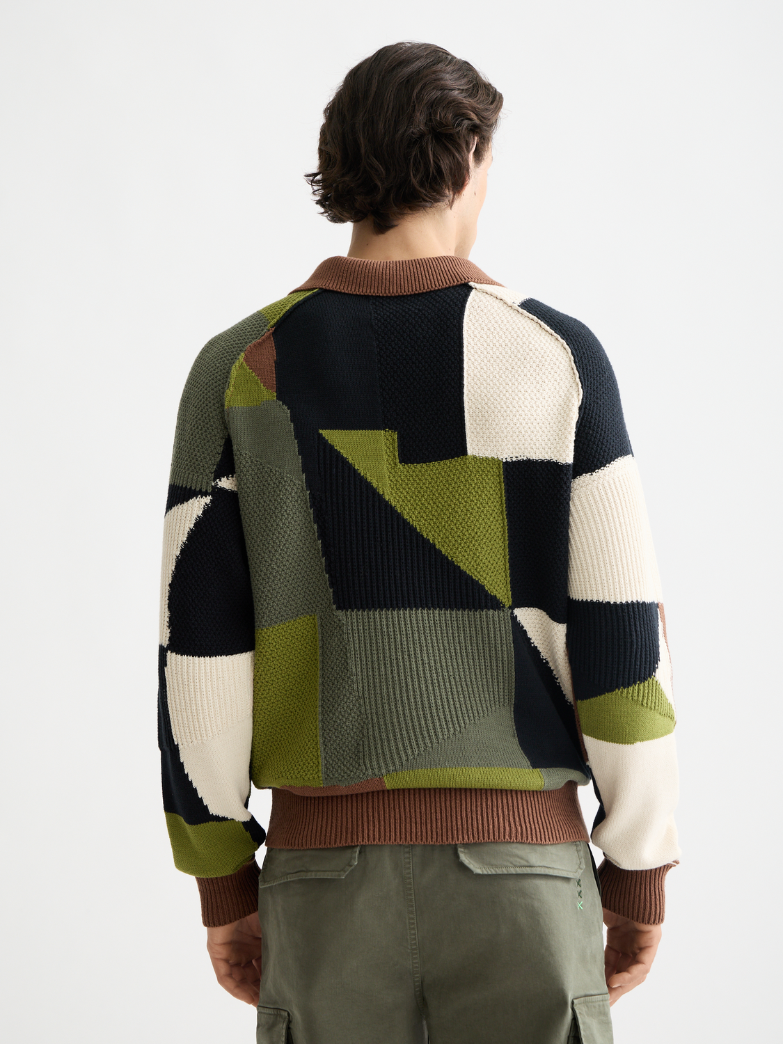 Patchwork long-sleeved knit polo shirt by Scotch & Soda, featuring a colorful patchwork design and ribbed cuffs.
