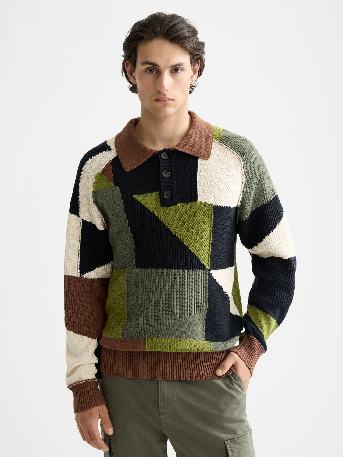 Patchwork long-sleeved knit polo shirt by Scotch & Soda, featuring a colorful, textured patchwork design with a classic collar.