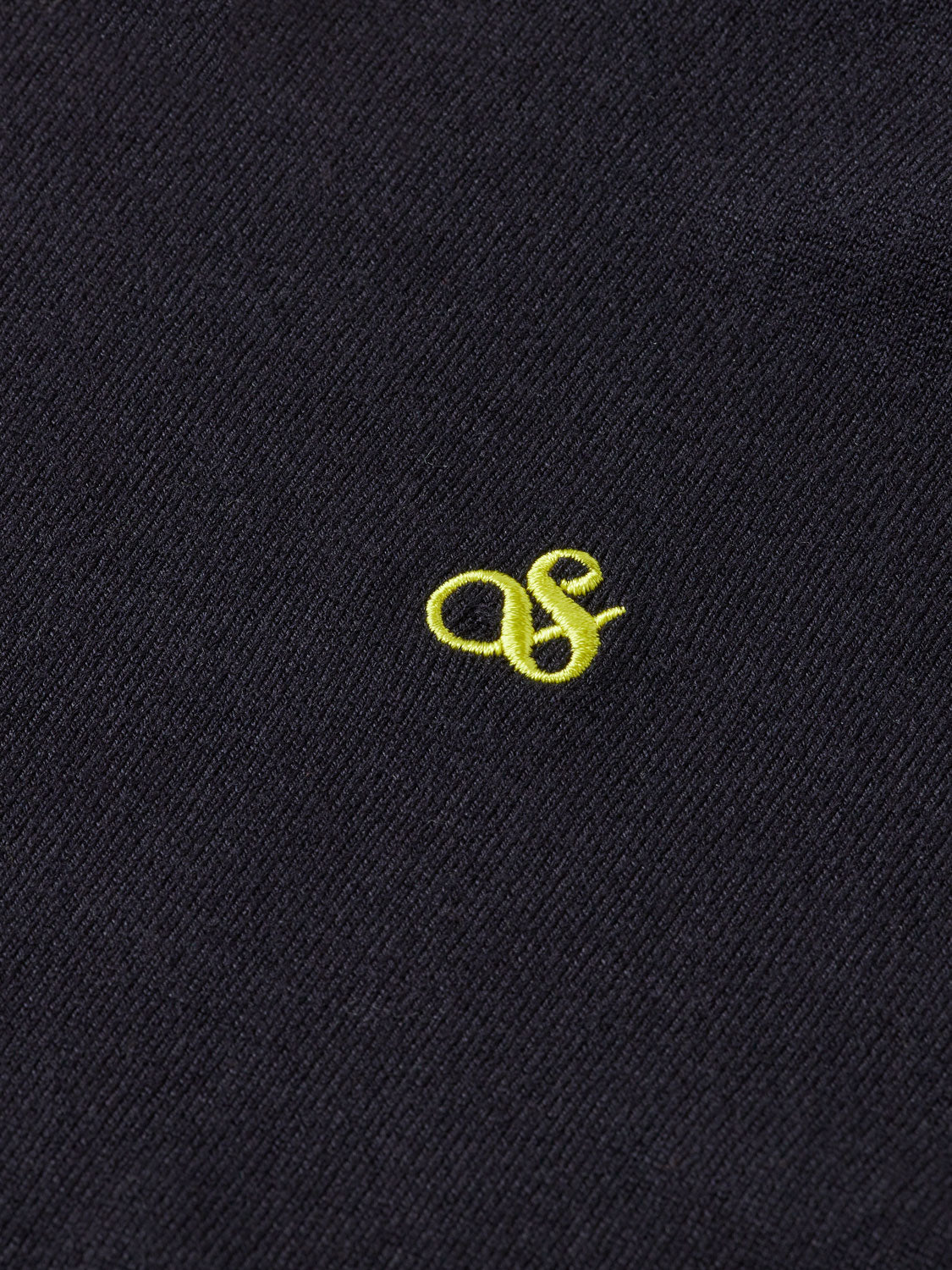 Cream knit turtleneck sweater by Scotch & Soda, close-up of ribbed collar and soft textured fabric.