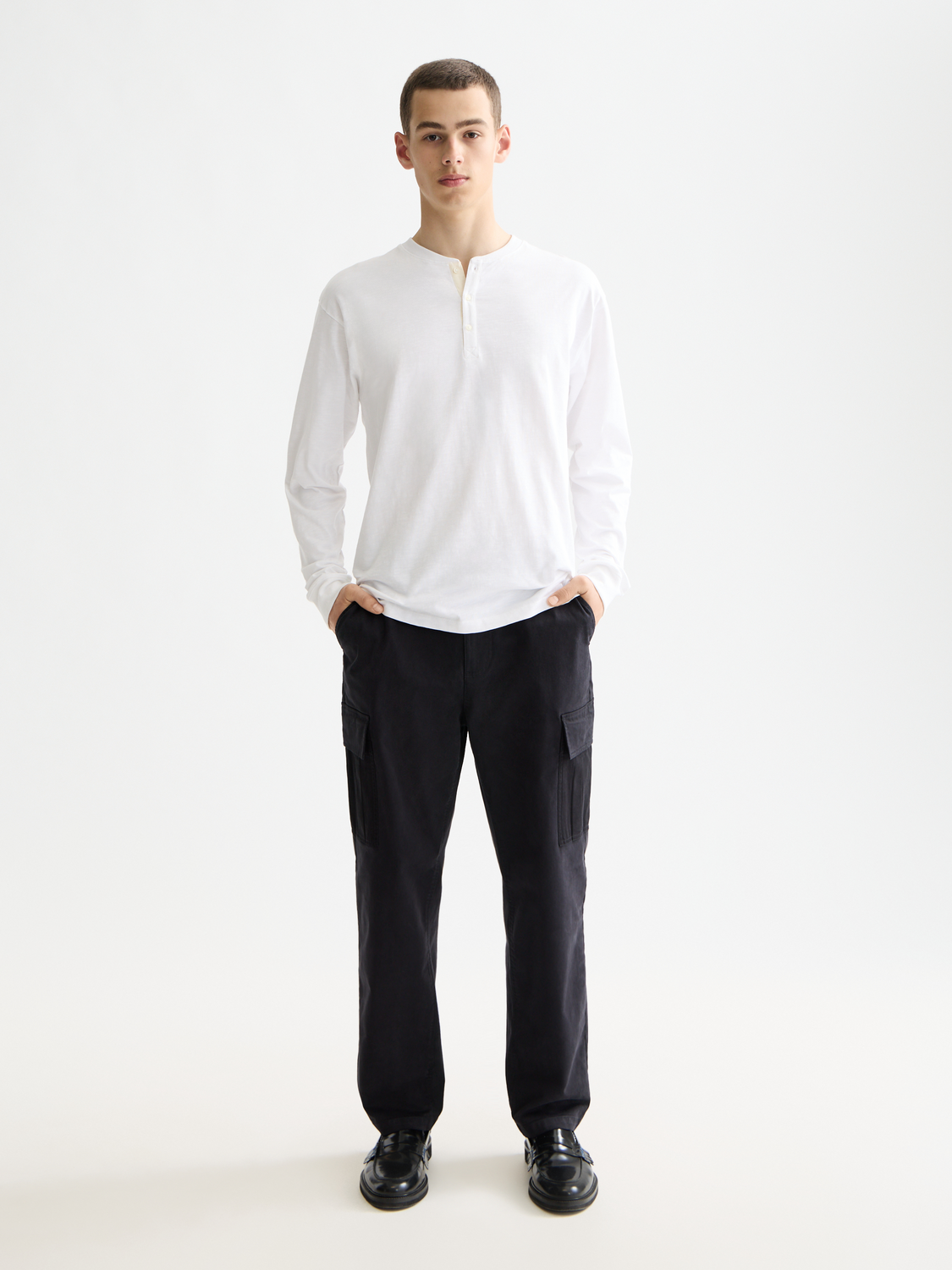 Long-sleeve Slub Henley t-shirt by Scotch & Soda in a natural fabric with buttons, displayed on a model.