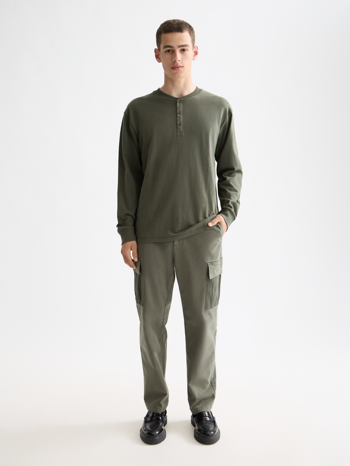 Long sleeve slub Henley t-shirt by Scotch & Soda, featuring a textured fabric and button placket in a neutral color.