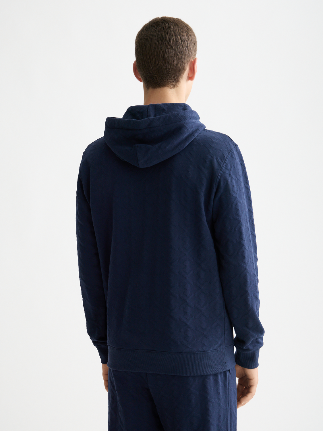 SCOTCH & SODA Jacquard terry hoodie, navy blue sweats with textured jacquard pattern, front view showing hoodie and cuffs.