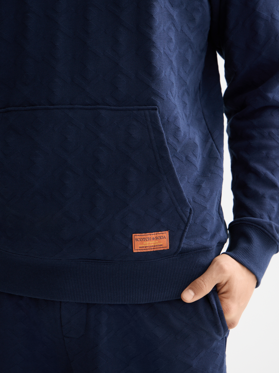 Scotch & Soda jacquard terry hoodie, cozy sweats with patterned fabric, front pocket and drawstring hood.