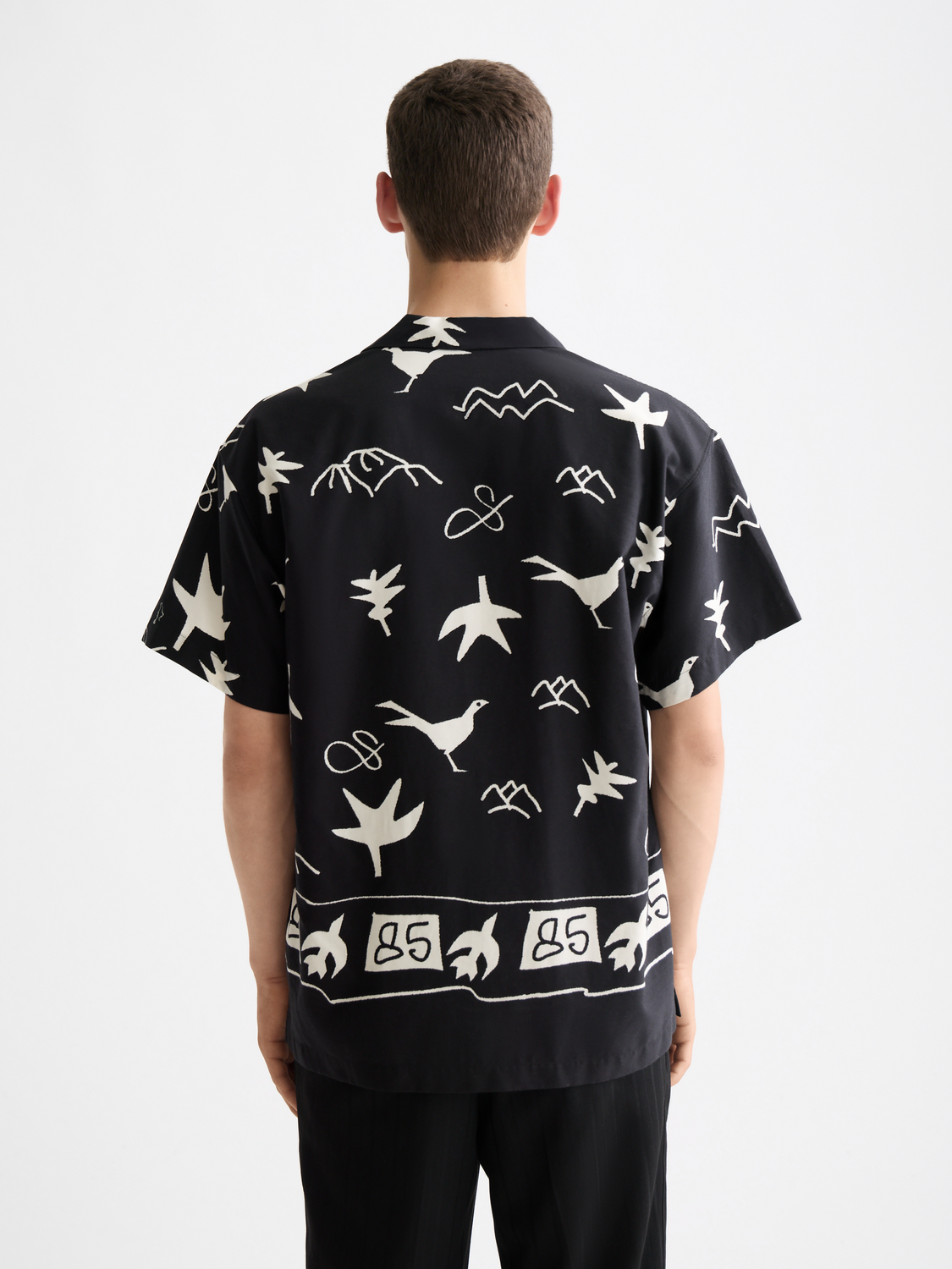 Short-sleeved Scotch & Soda shirt with a stylish print, shown from the back in this image.