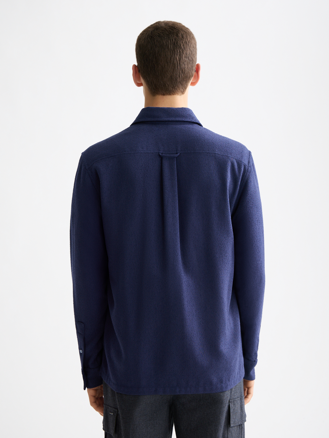 Long sleeve textured shirt by Scotch & Soda, shown in dark color with collar and button details.