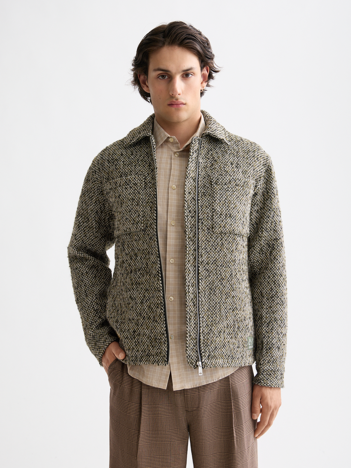 Scotch & Soda tweed jacket with classic check pattern, tailored fit, and textured fabric, displayed on a hanger.