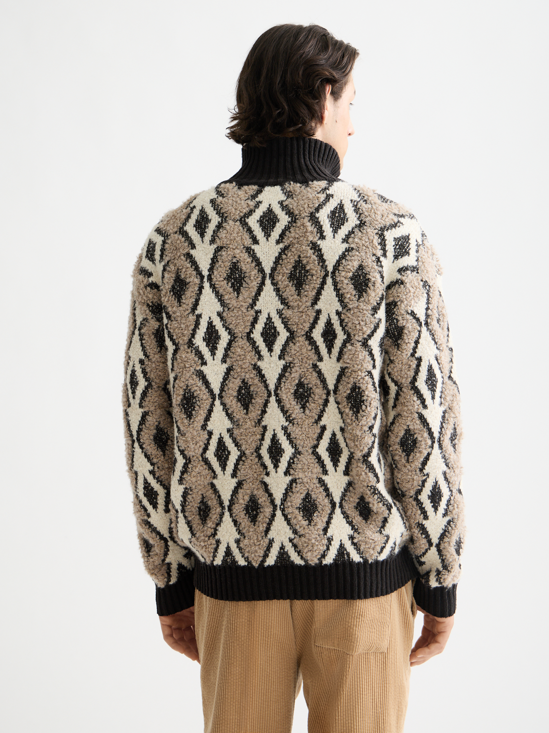 Back view of a Scotch & Soda jacquard knitwear pullover with intricate patterns in a cozy knit fabric.