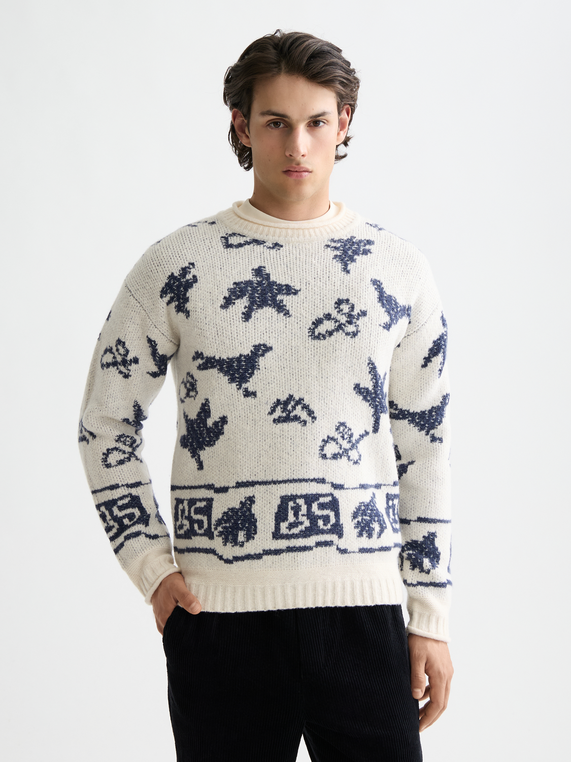 Scotch & Soda jacquard knitwear pullover featuring intricate patterns and a classic crew neckline, shown in a front view.